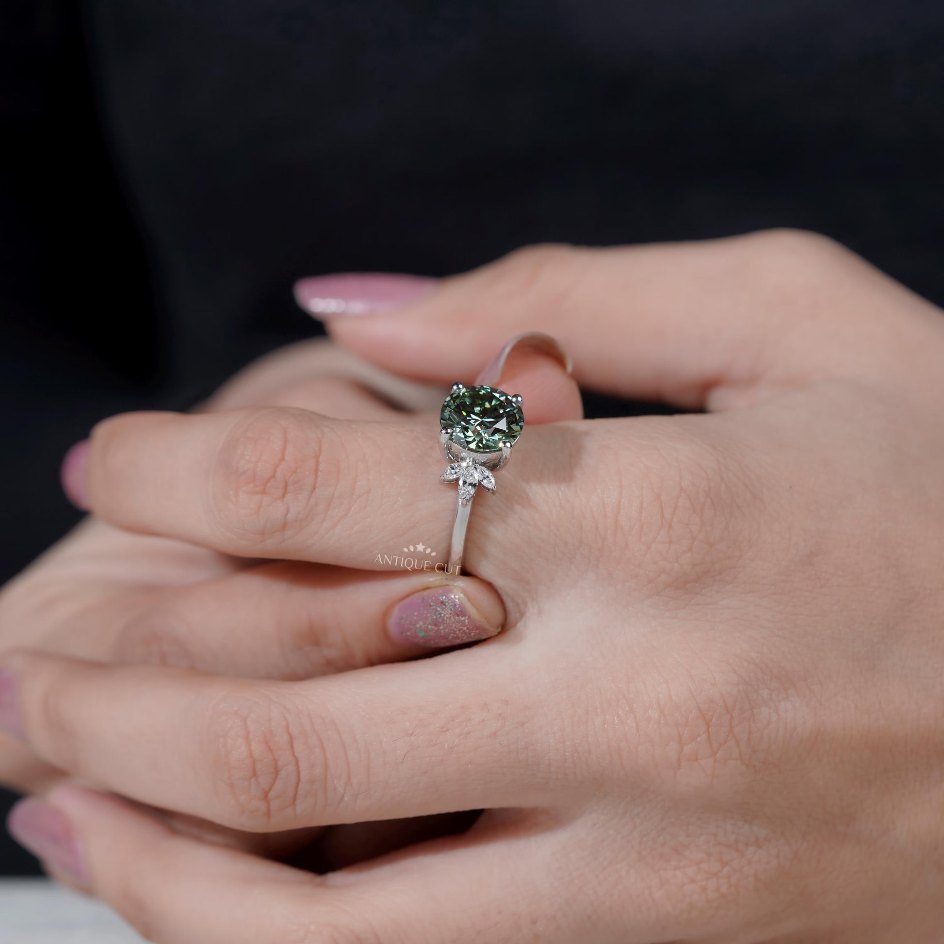 4 prong round green diamond ring with side stones