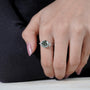 Elegant round green diamond ring with marquise sides