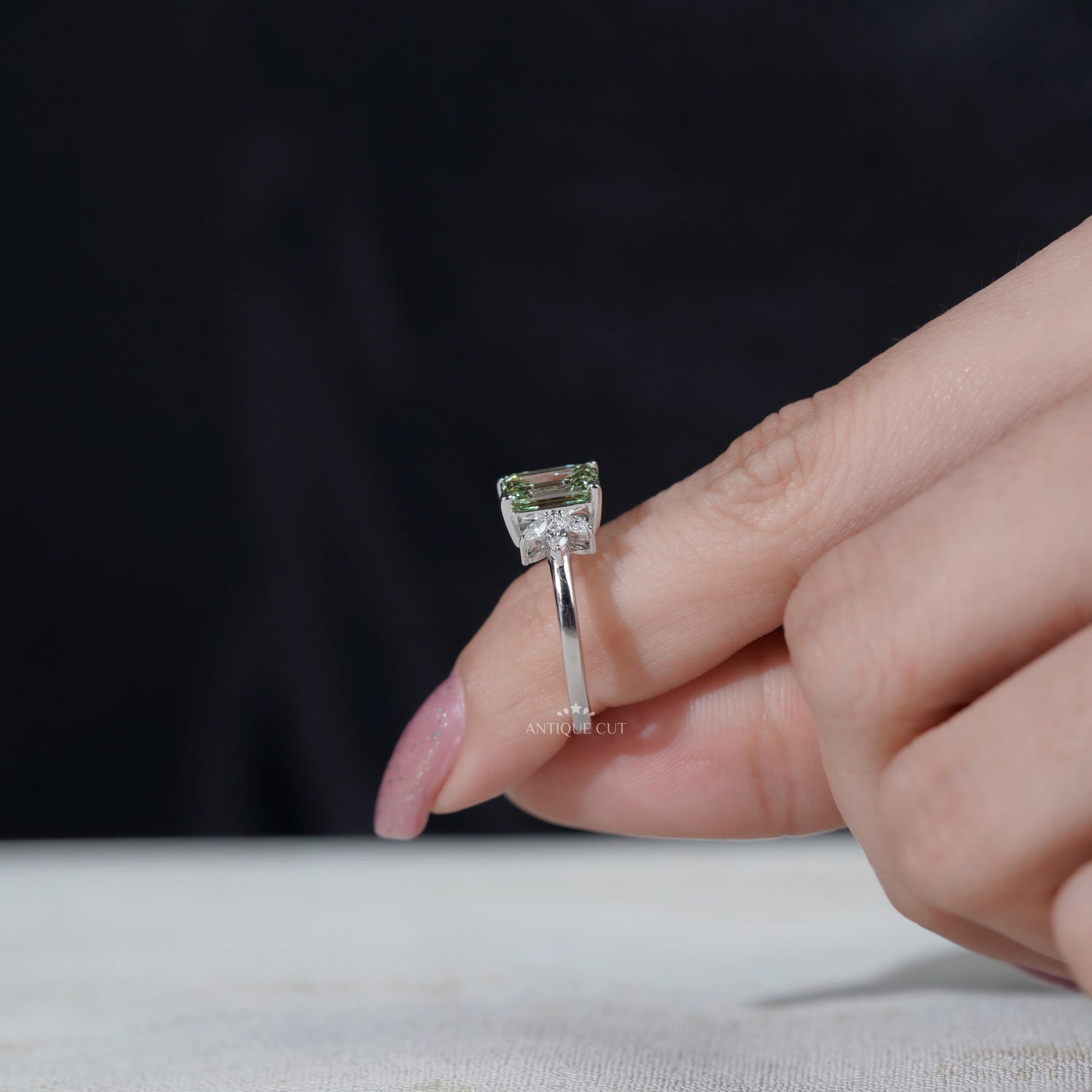 Elegant emerald cut light green diamond ring white gold