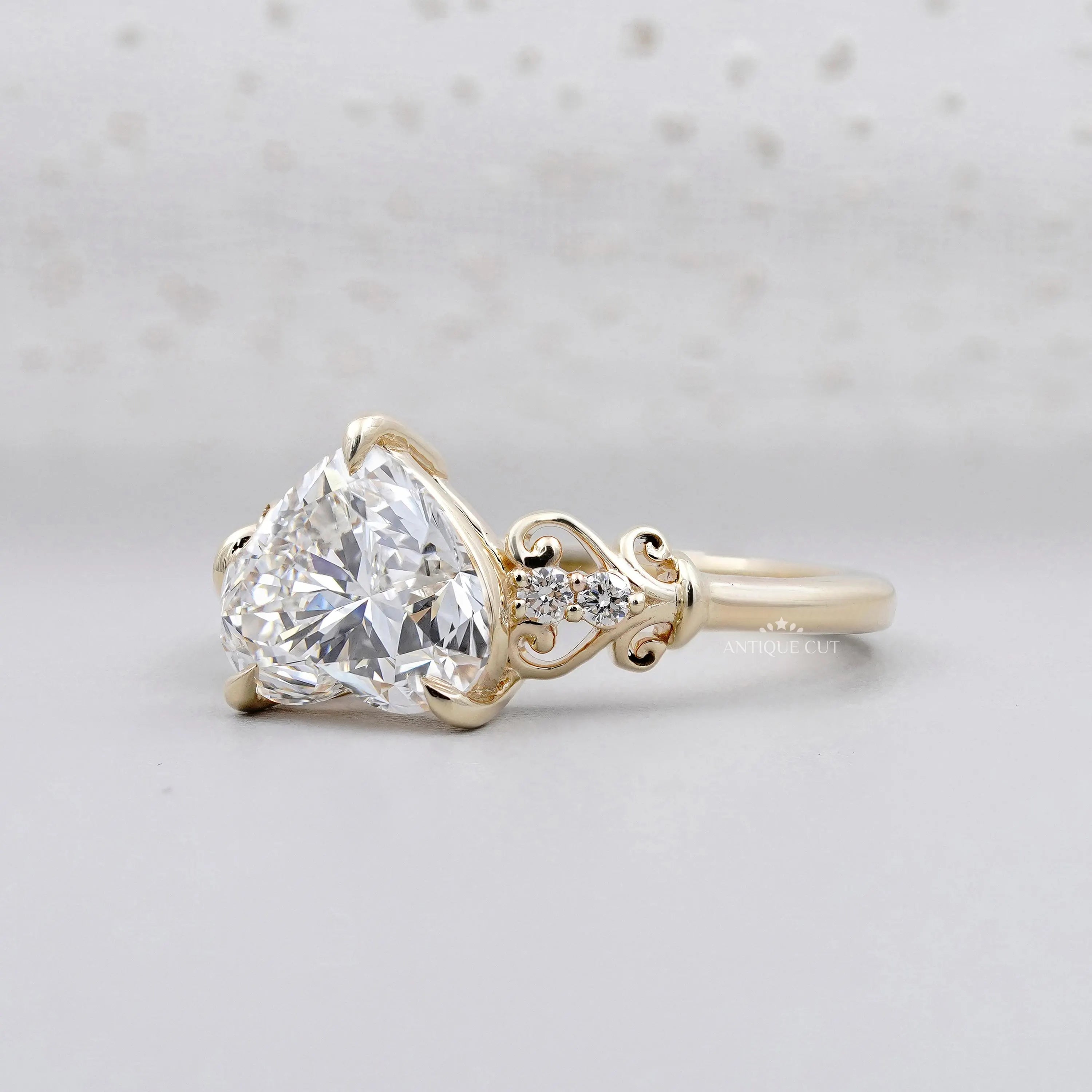 Yellow gold engagement ring with round cut side stones.