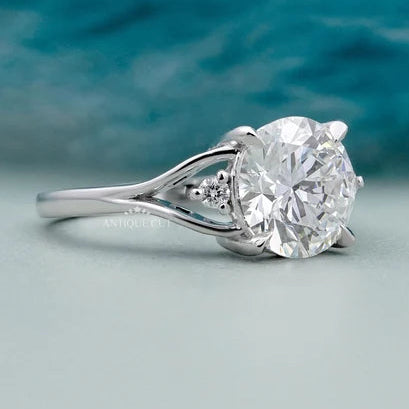 Round centre diamond engagement ring with side diamonds