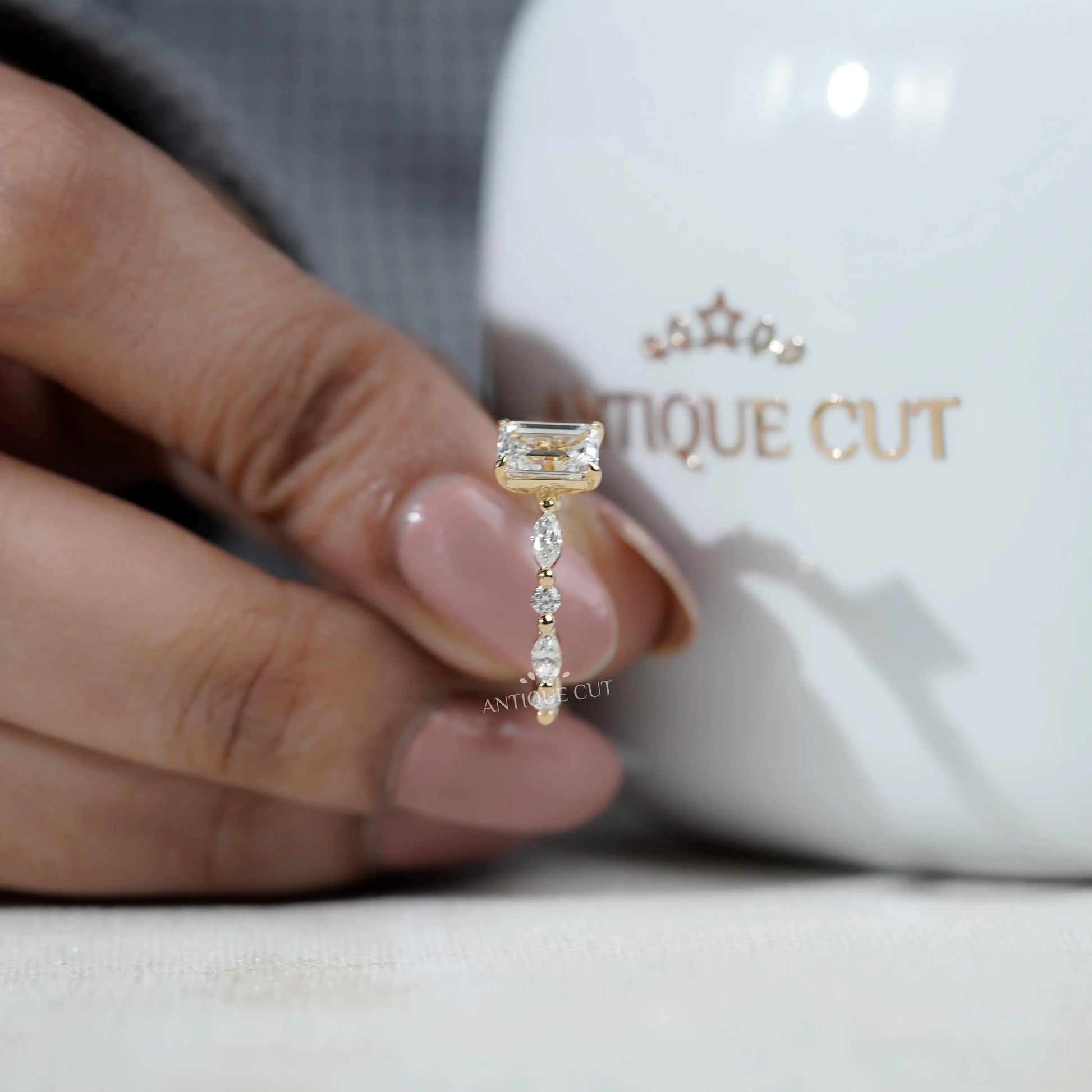 Classic emerald cut engagement ring with side stones