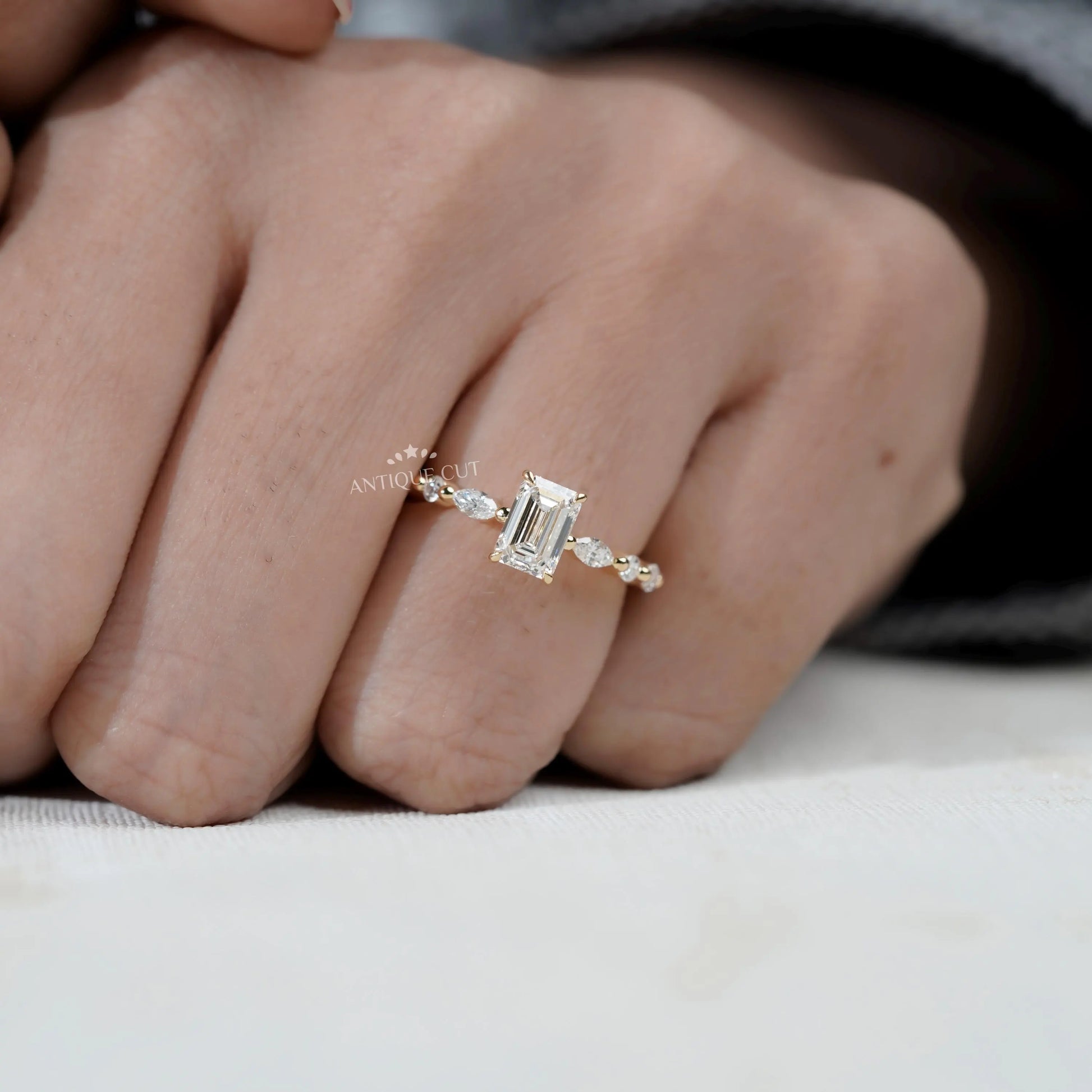 Elegant emerald cut diamond ring with side stone detail