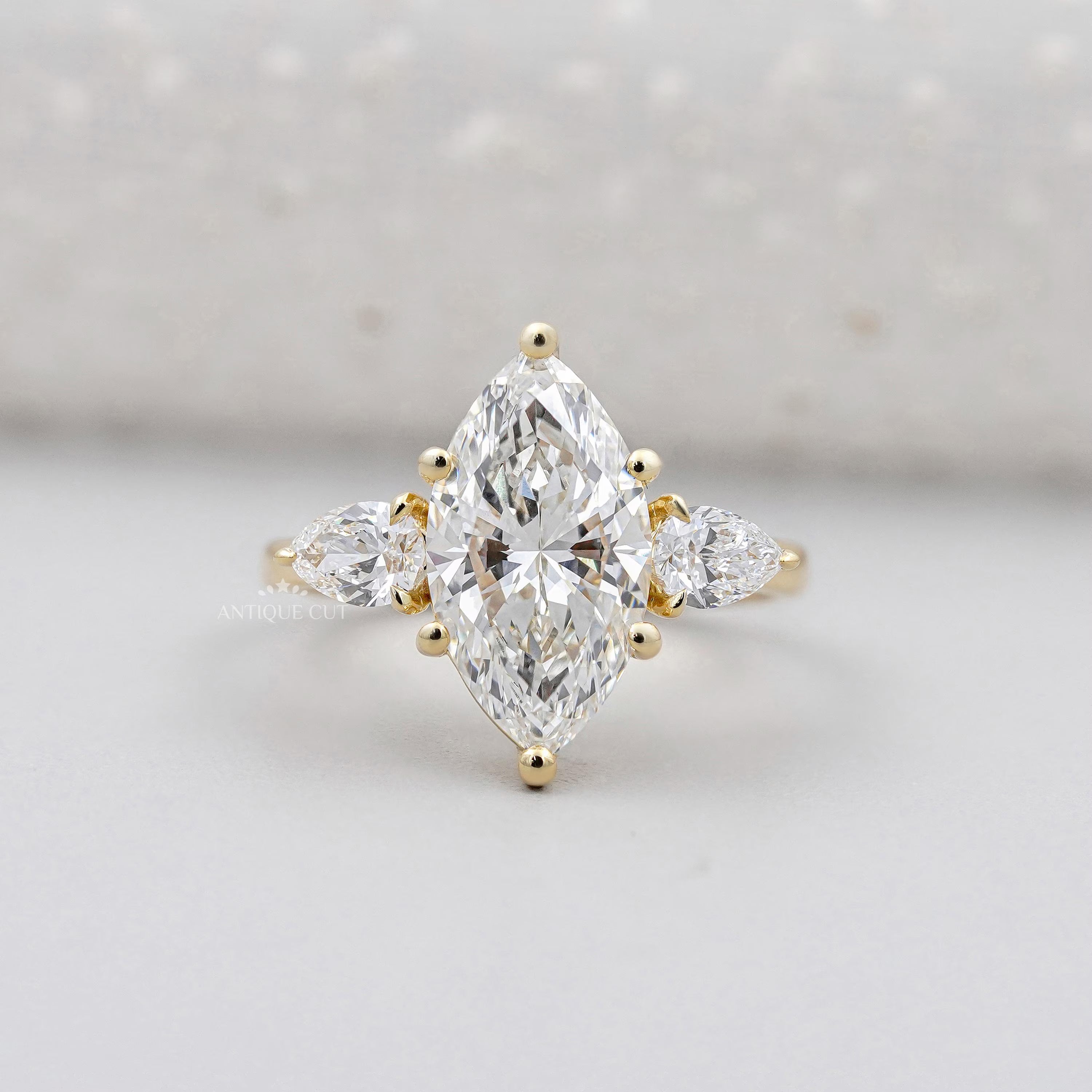 Marquise cut engagement ring in yellow gold three stone