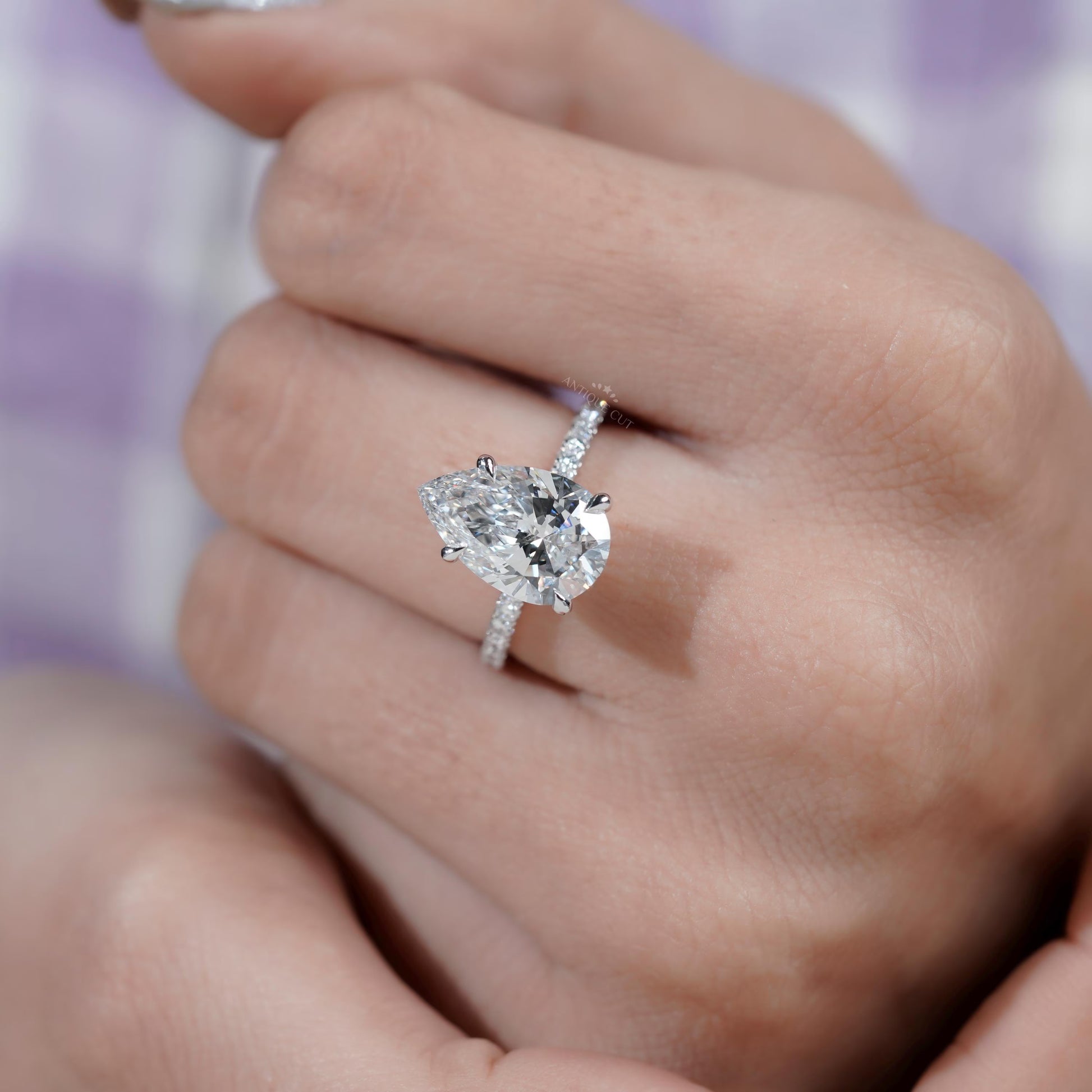 Pear diamond ring side view with round side stones