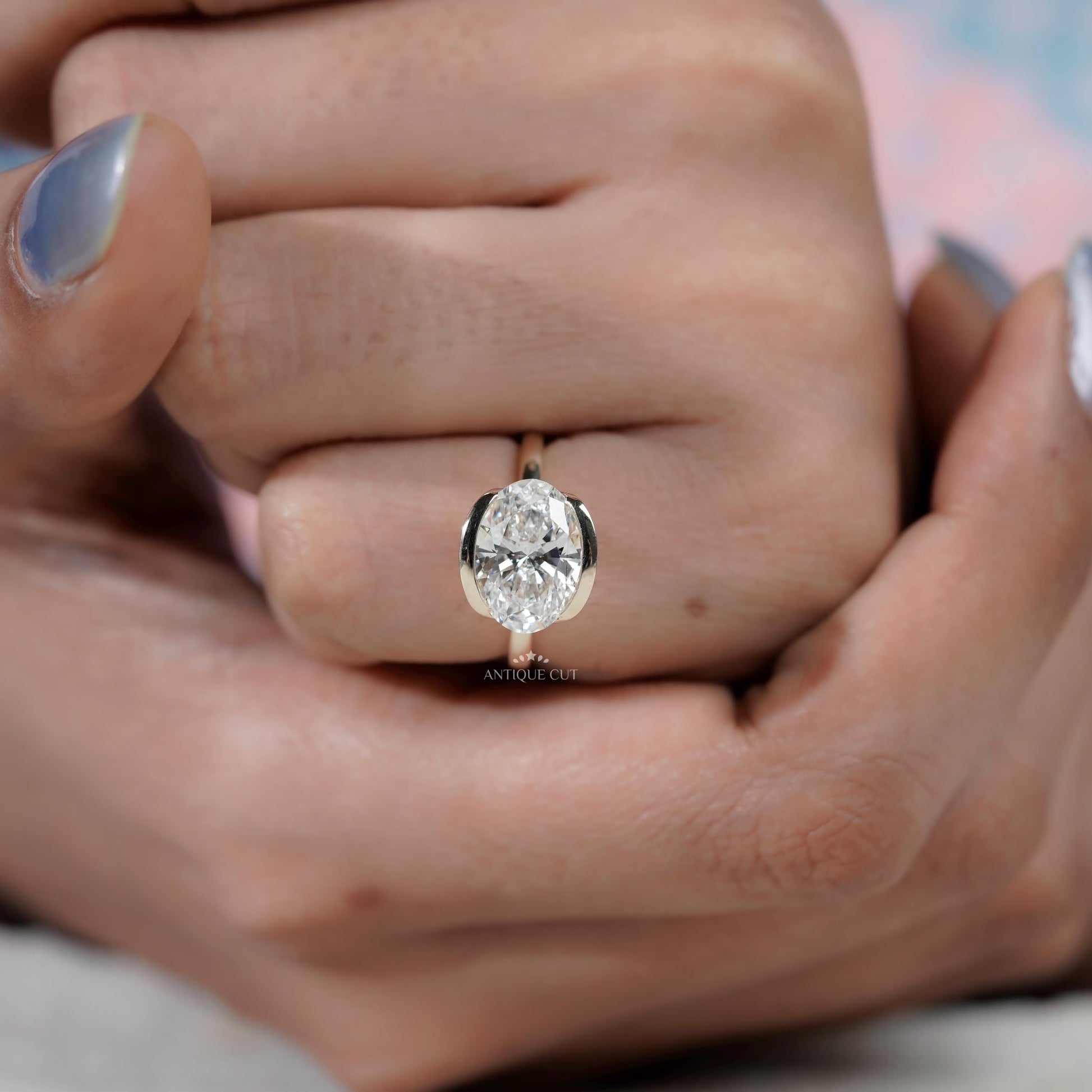 sleek bezel set oval engagement ring