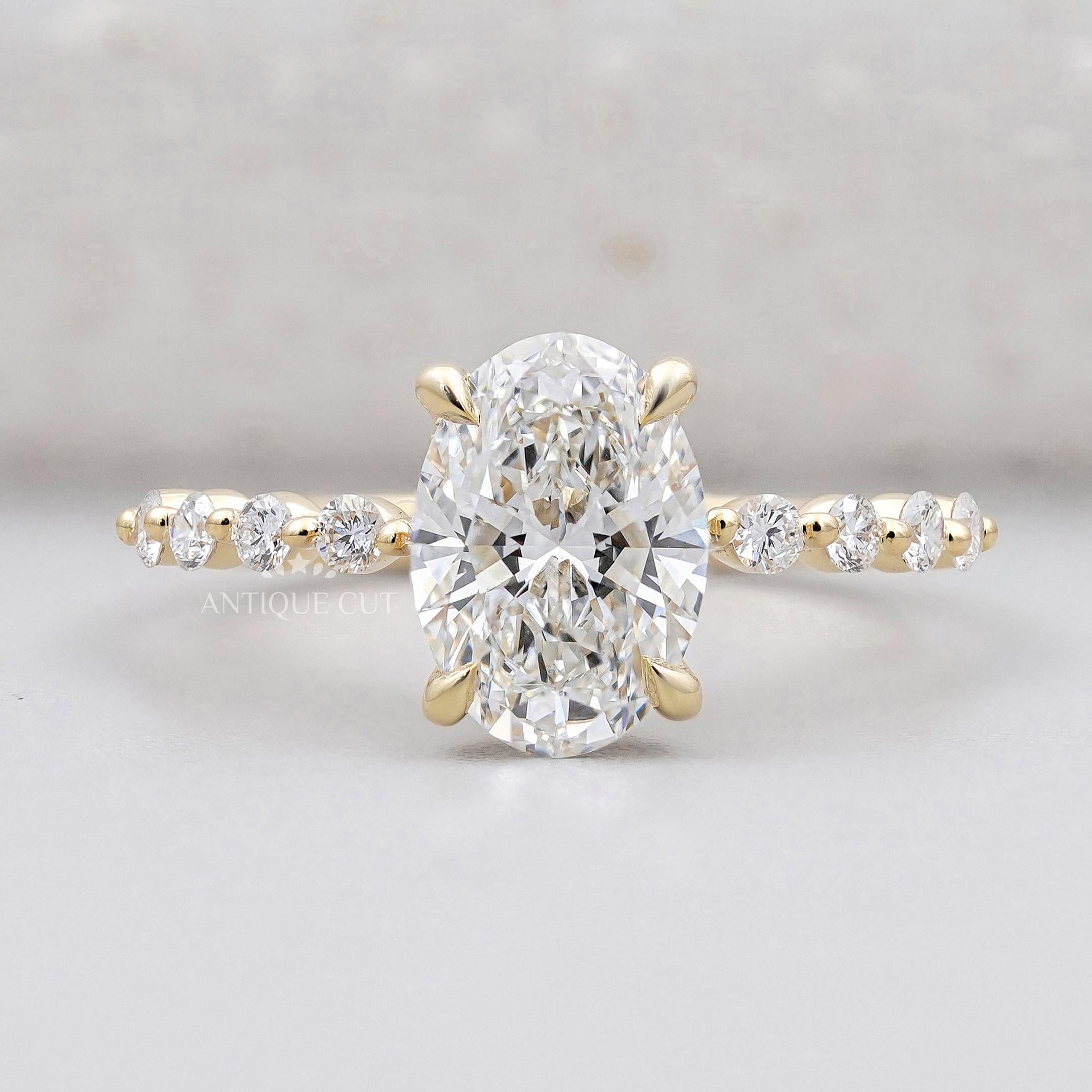Oval cut hidden halo diamond engagement ring in yellow gold