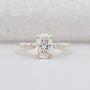 Oval cut hidden halo diamond engagement ring in yellow gold