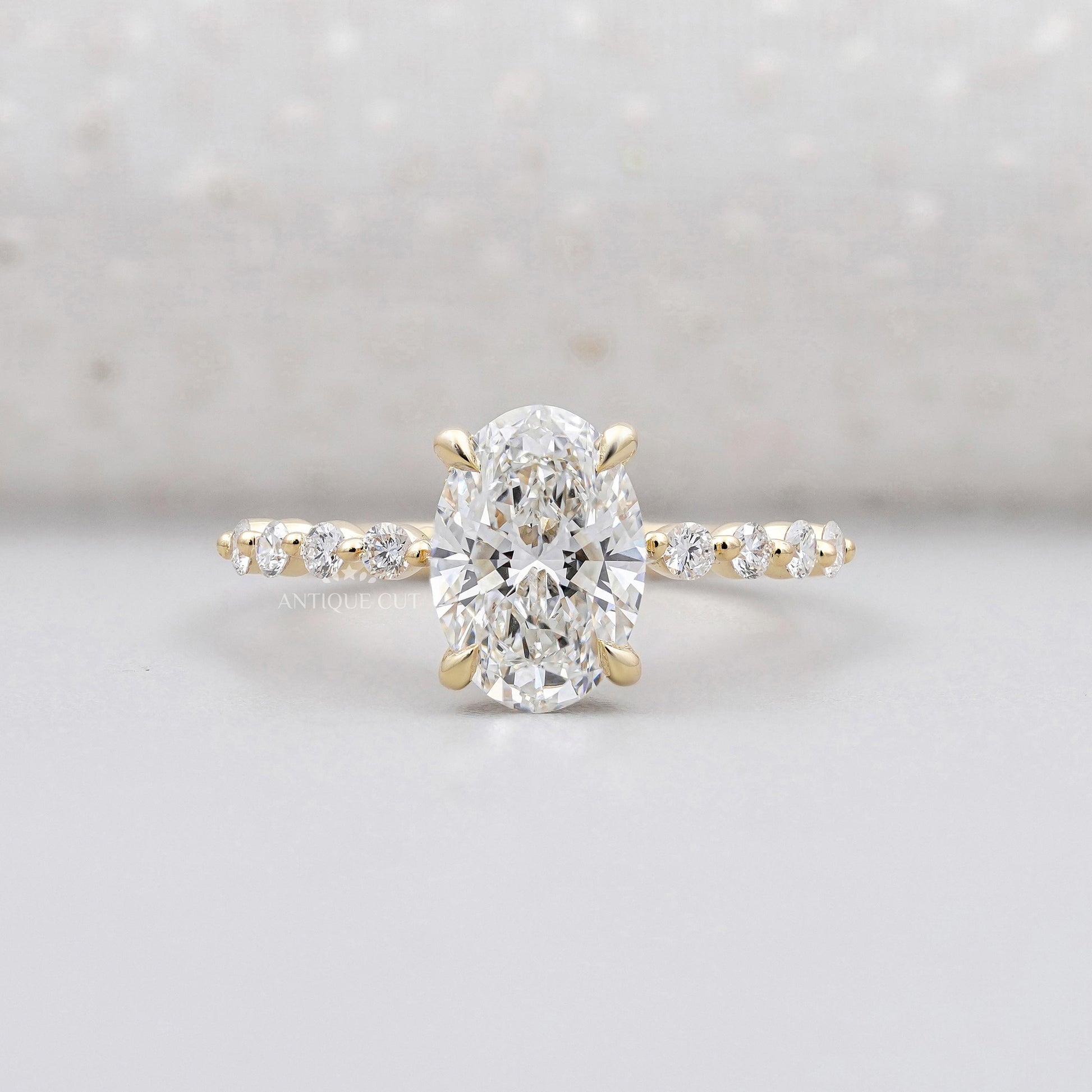 Oval cut hidden halo diamond engagement ring in yellow gold