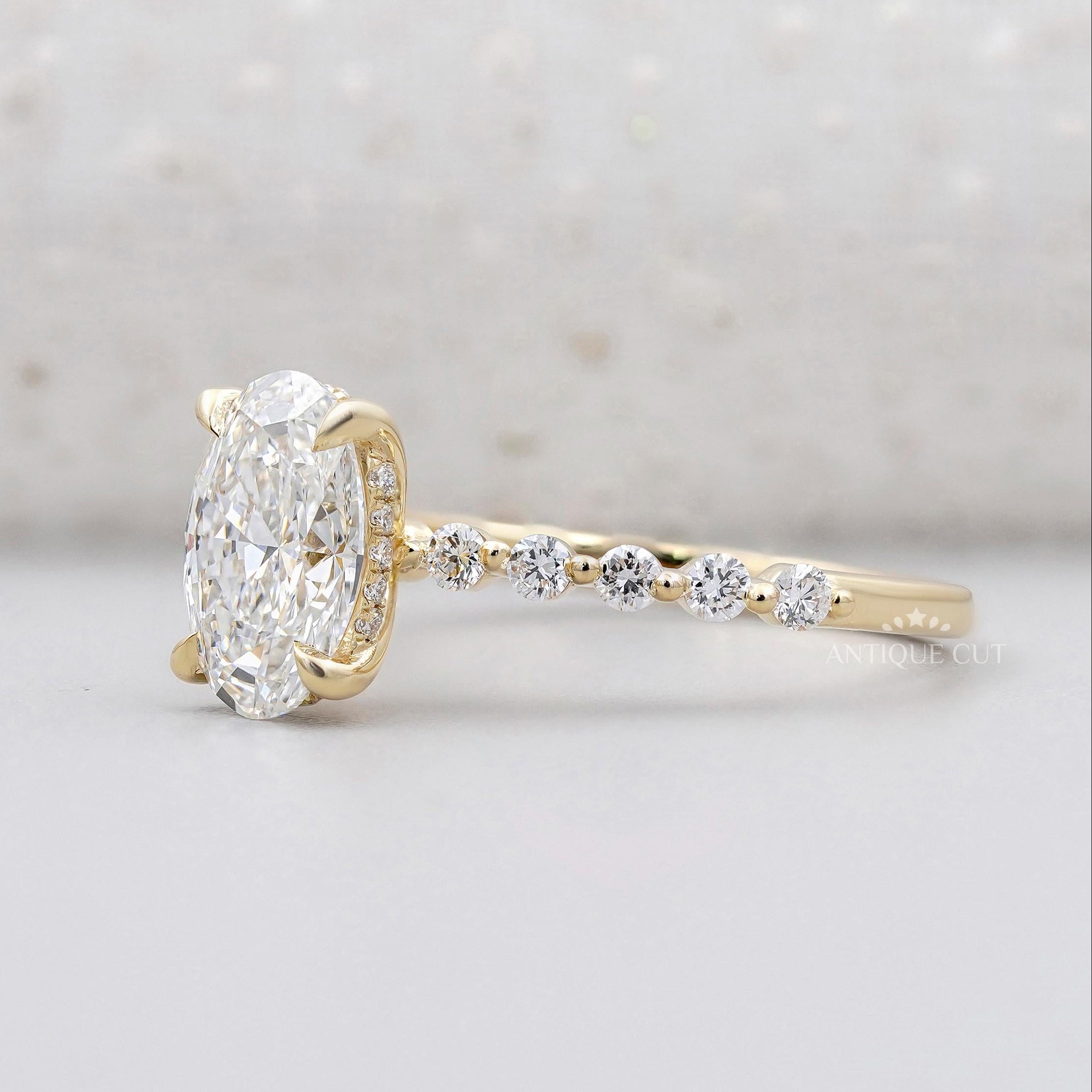 Yellow gold oval diamond ring with hidden halo and pave band