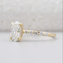 Yellow gold oval diamond ring with hidden halo and pave band