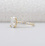 Yellow gold oval diamond ring with hidden halo and pave band