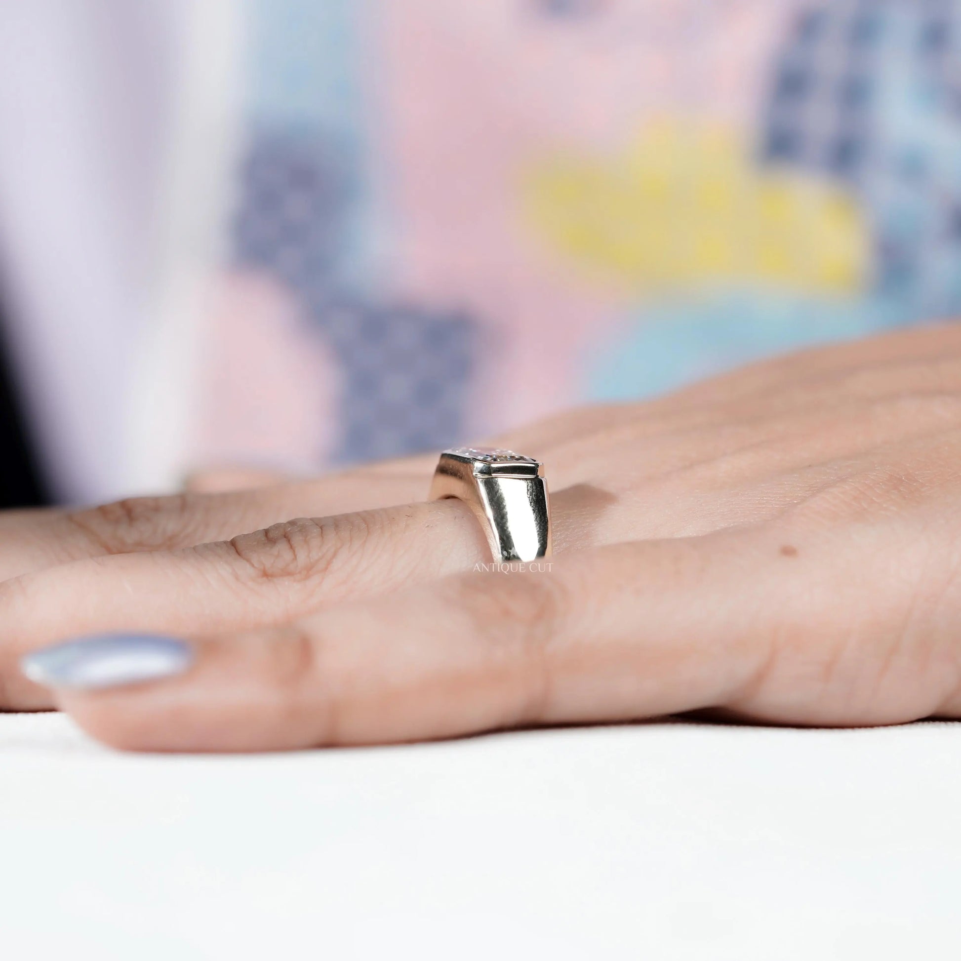 sleek bezel set emerald diamond ring