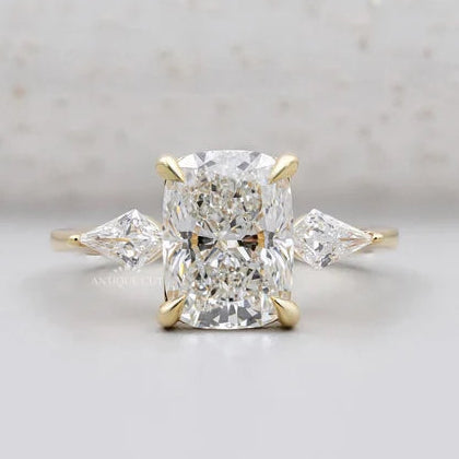Yellow gold cushion cut diamond ring with kite side stones