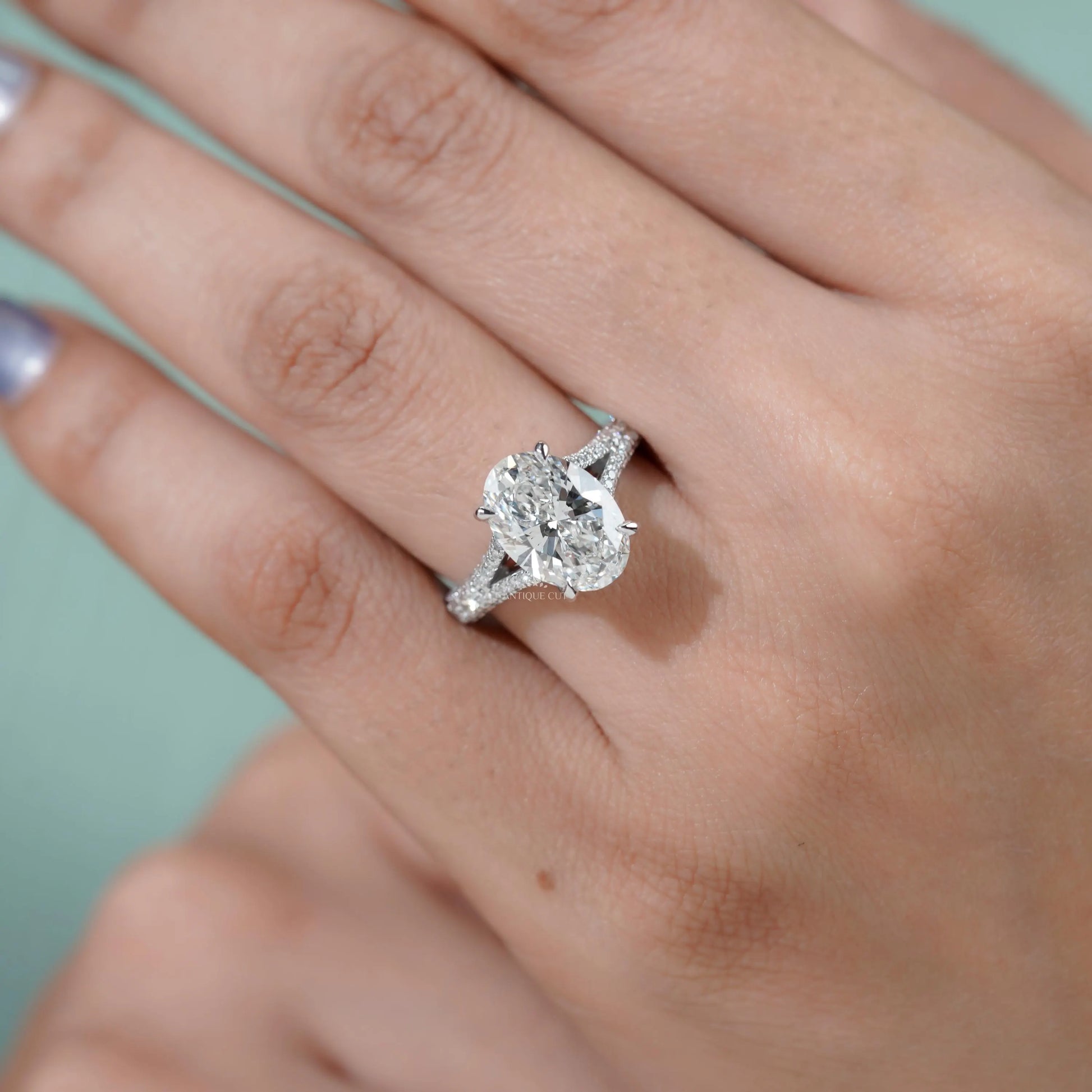 Close-up of pave diamond band on oval engagement ring