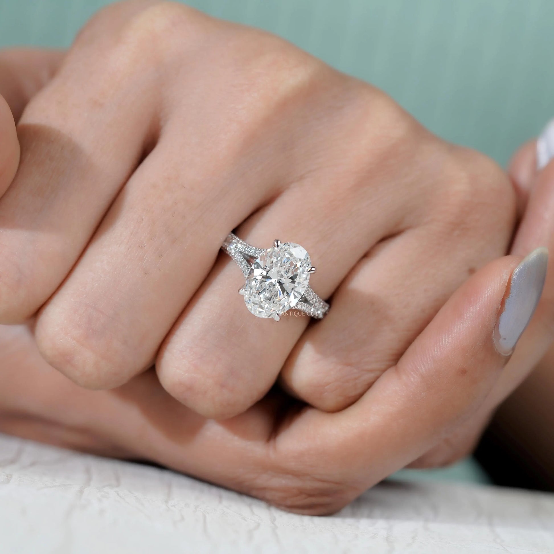 Oval center diamond ring with dazzling pave band