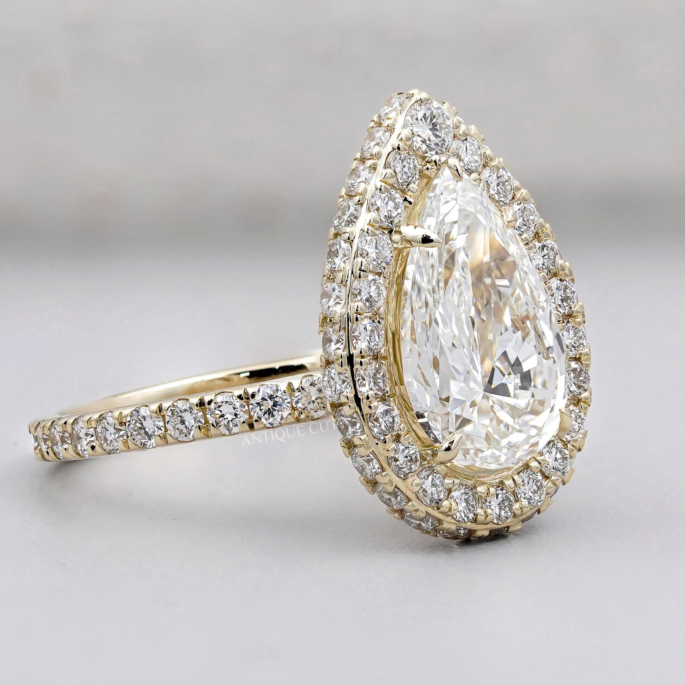 White gold pear engagement ring with pave band
