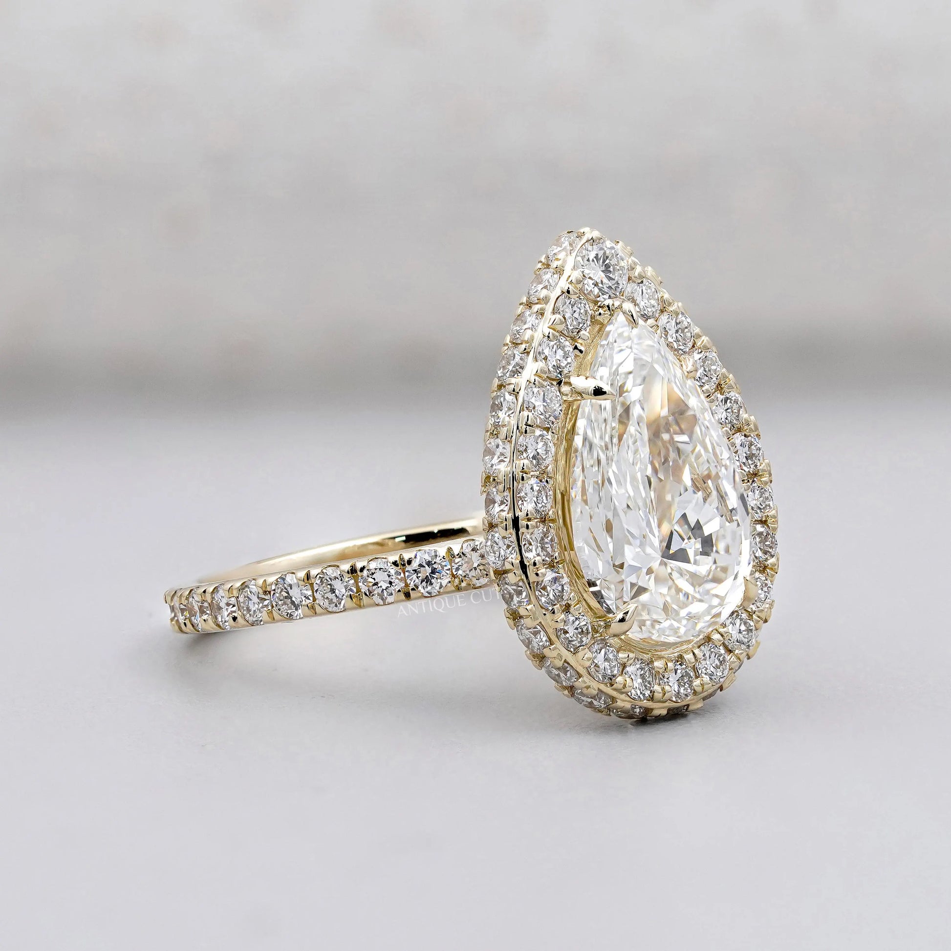 White gold pear engagement ring with pave band