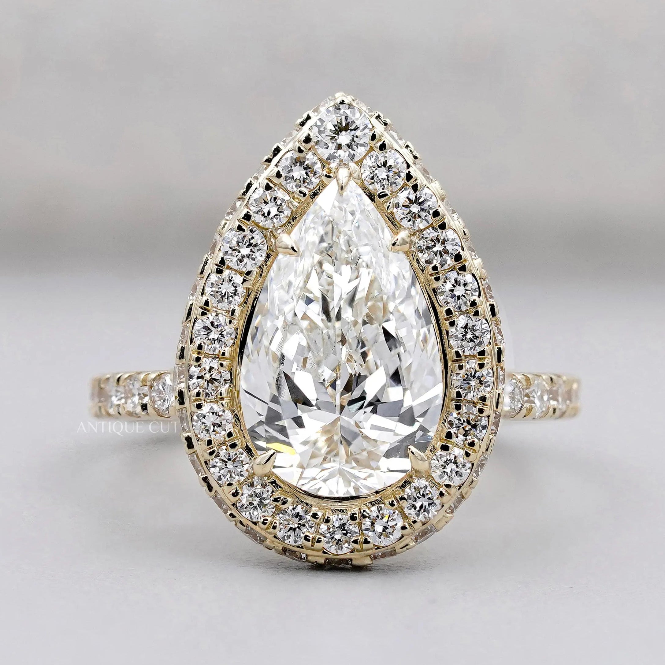 Pear shape engagement ring with halo diamond setting