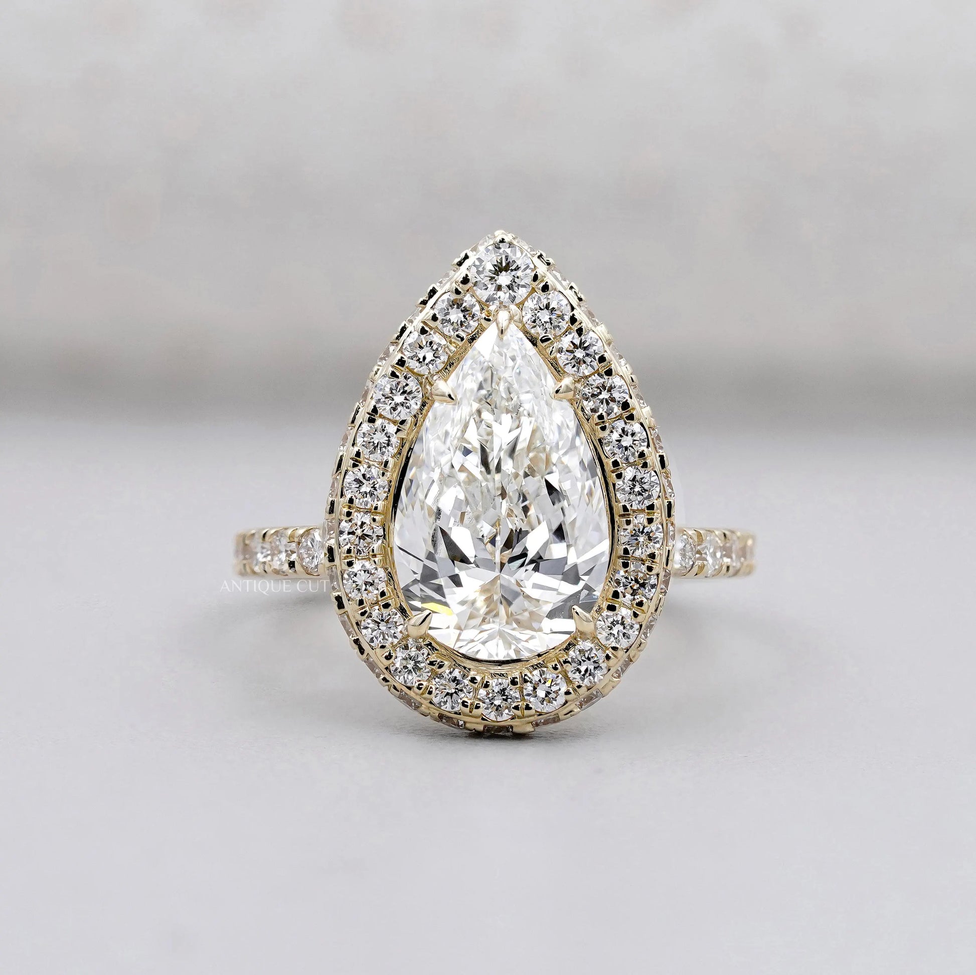 Pear shape engagement ring with halo diamond setting