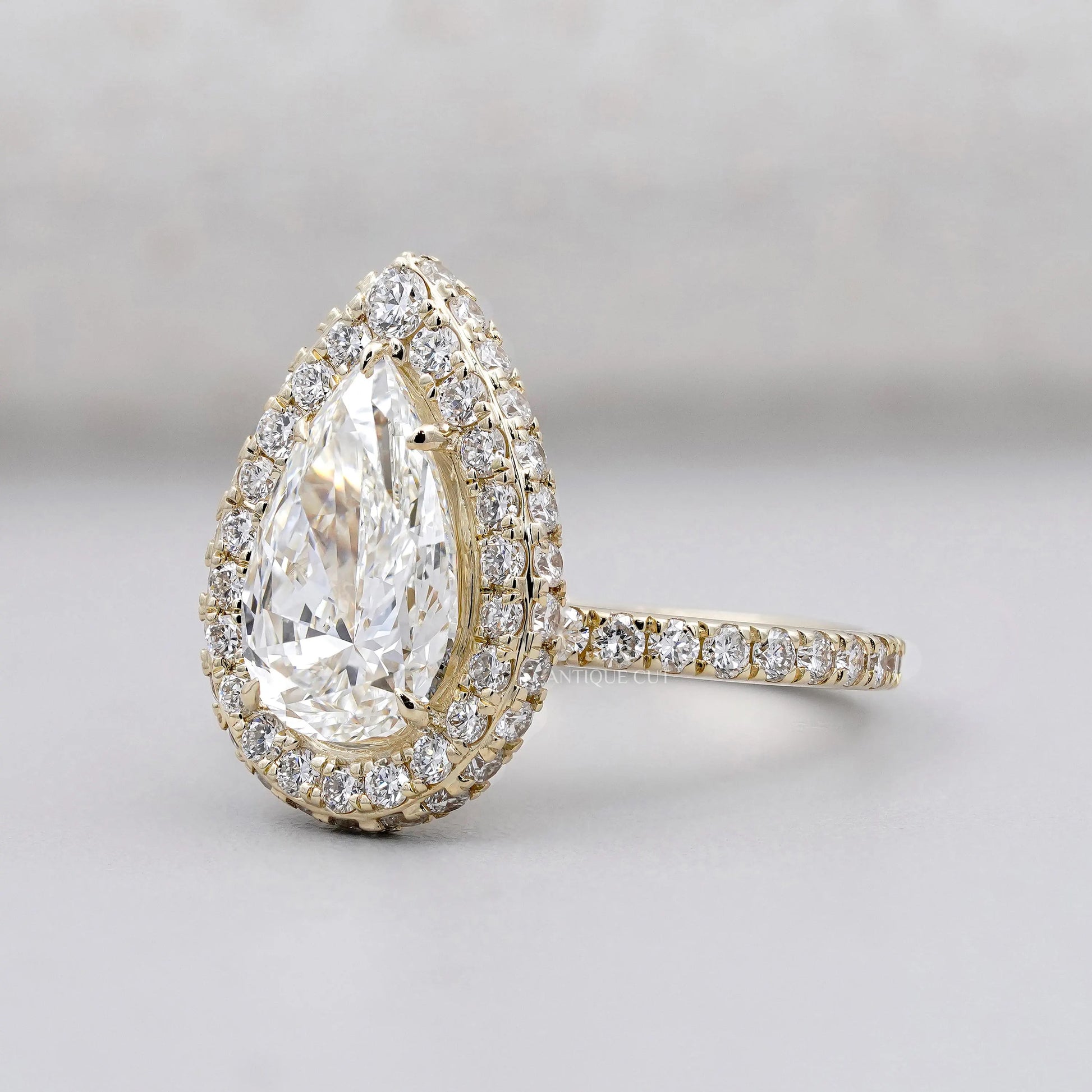 Halo diamond ring with pear shaped center stone