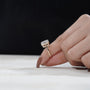 Hand-set emerald with solitaire accent