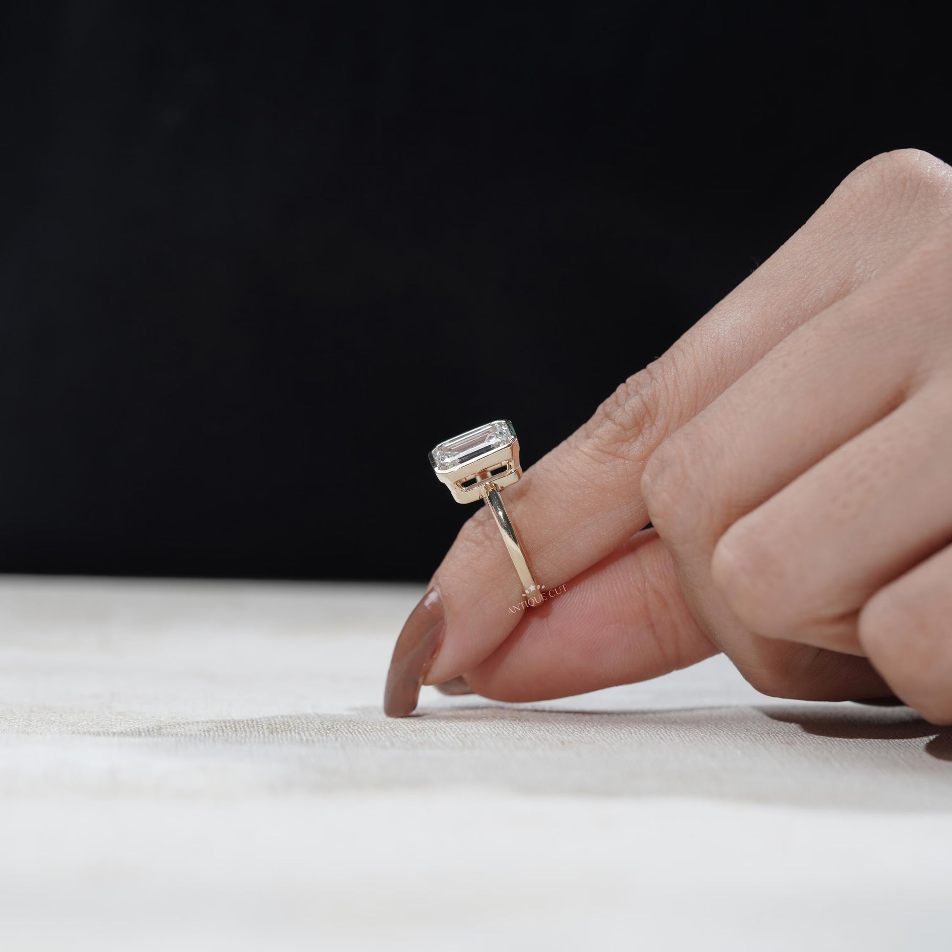 Hand-set emerald with solitaire accent