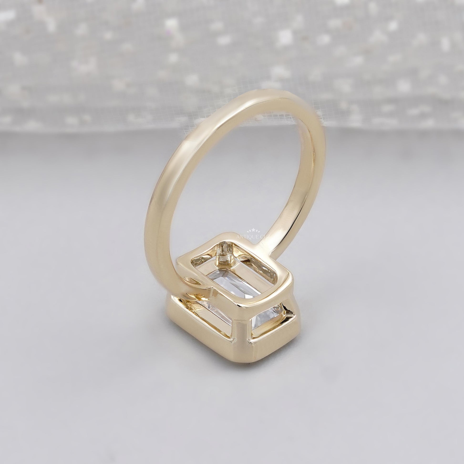 Emerald cut diamond ring with secure bezel set design