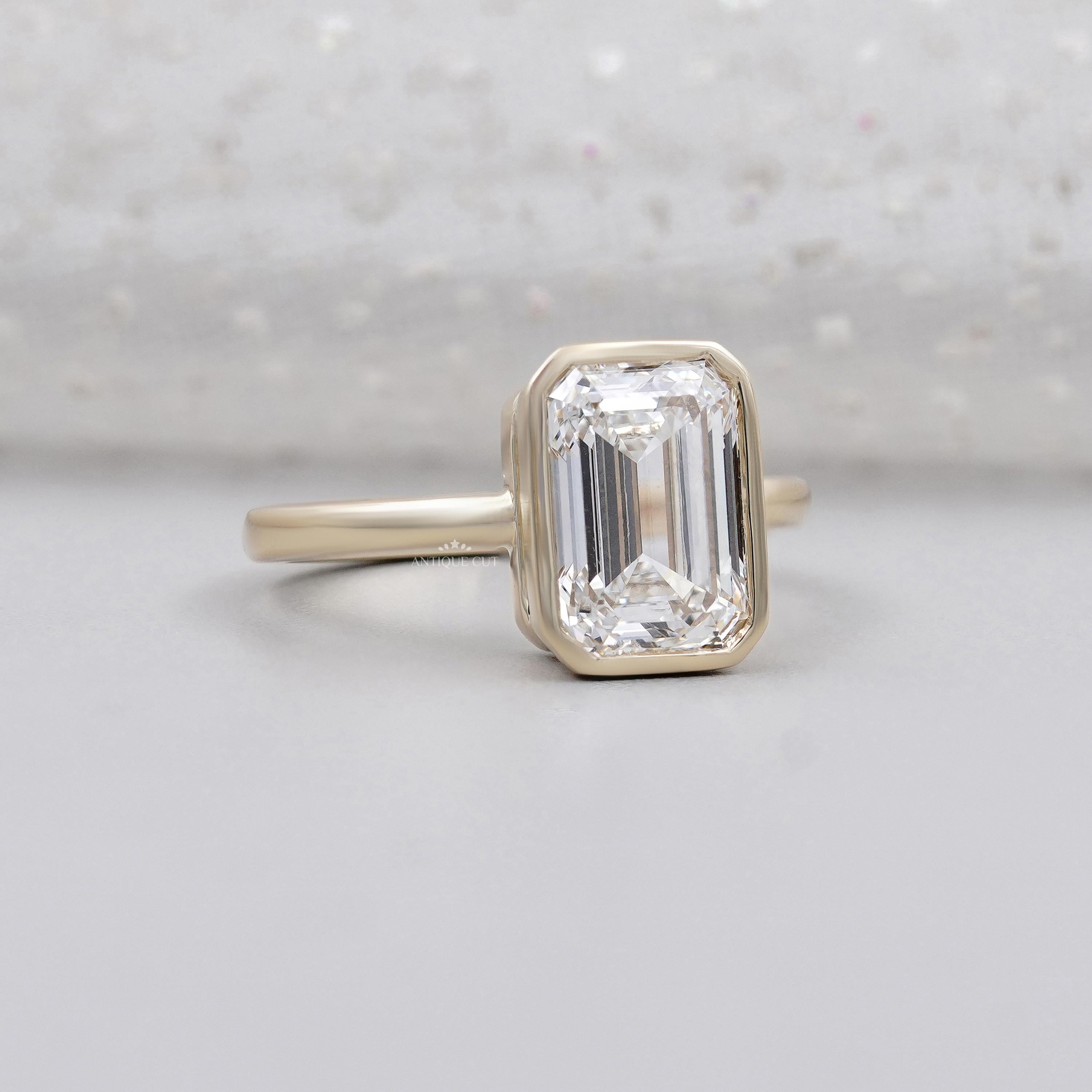 Emerald cut diamond bezel solitaire engagement ring in yellow gold