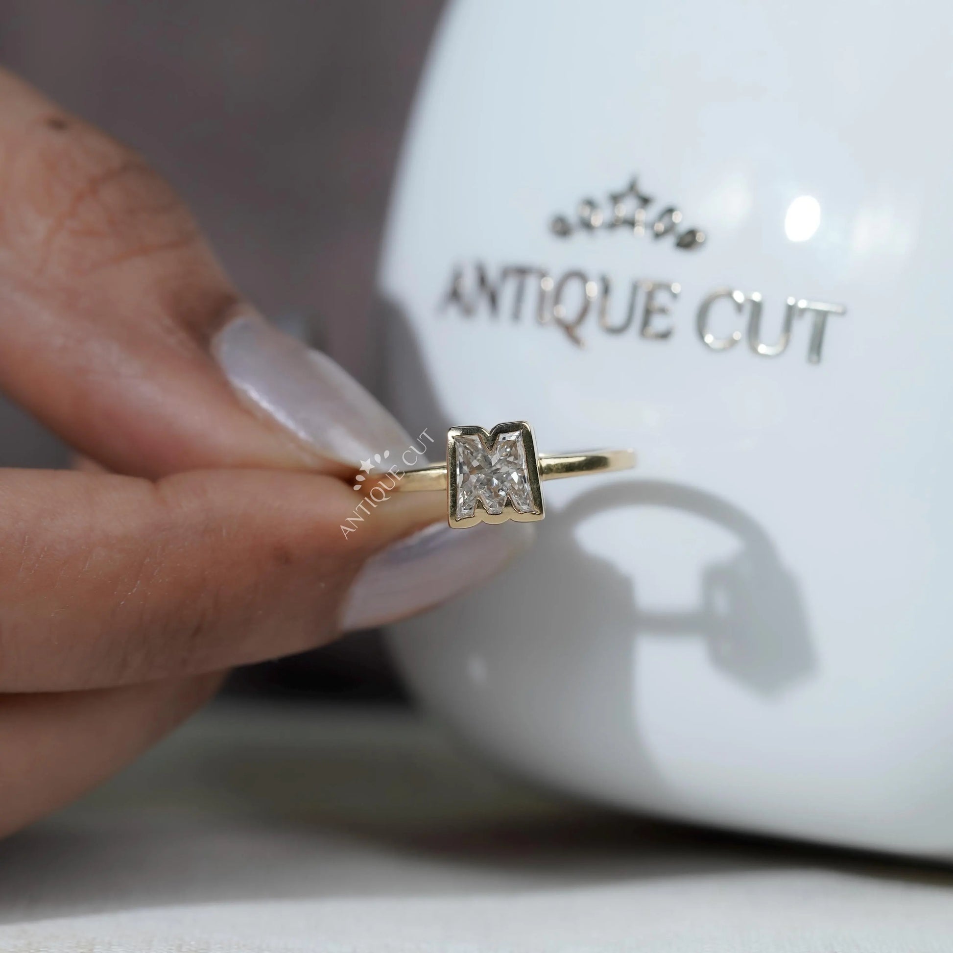 M initial engagement ring yellow gold detail
