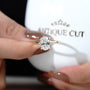 Oval solitaire ring with hidden halo detail