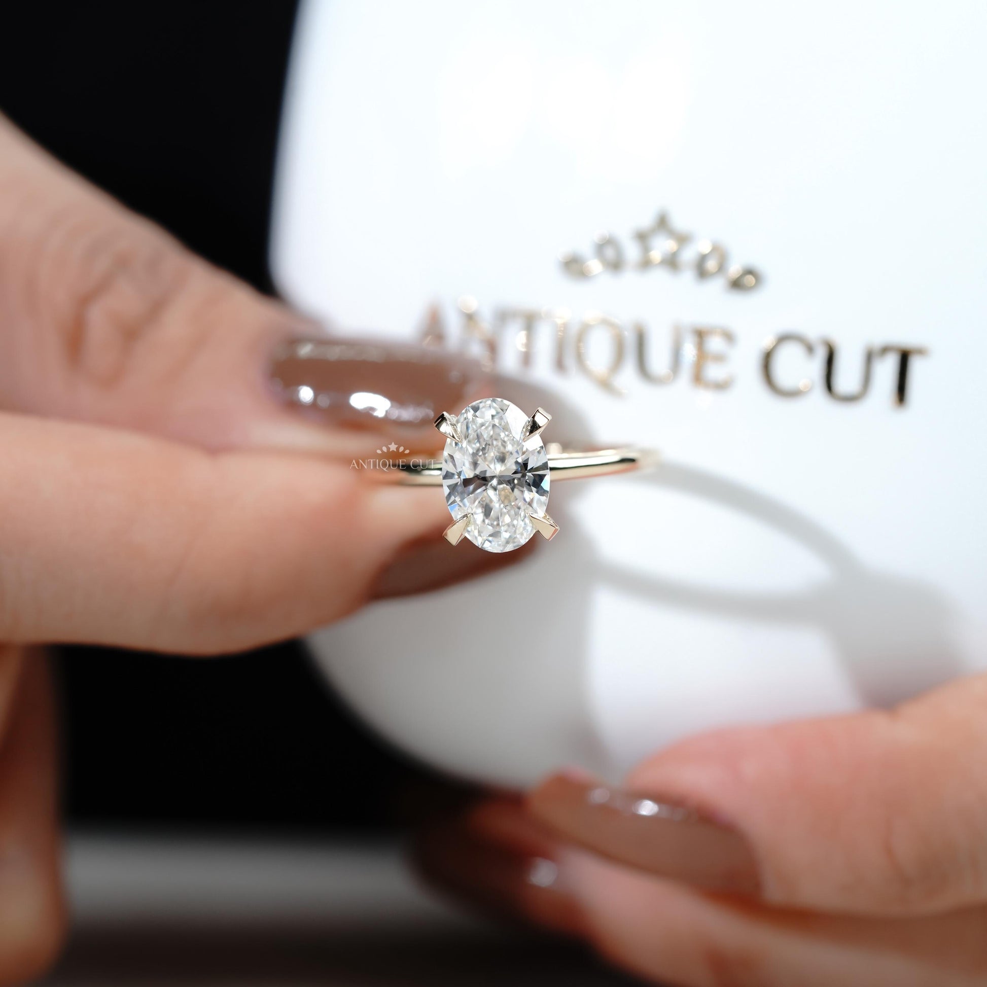 Oval solitaire ring with hidden halo detail