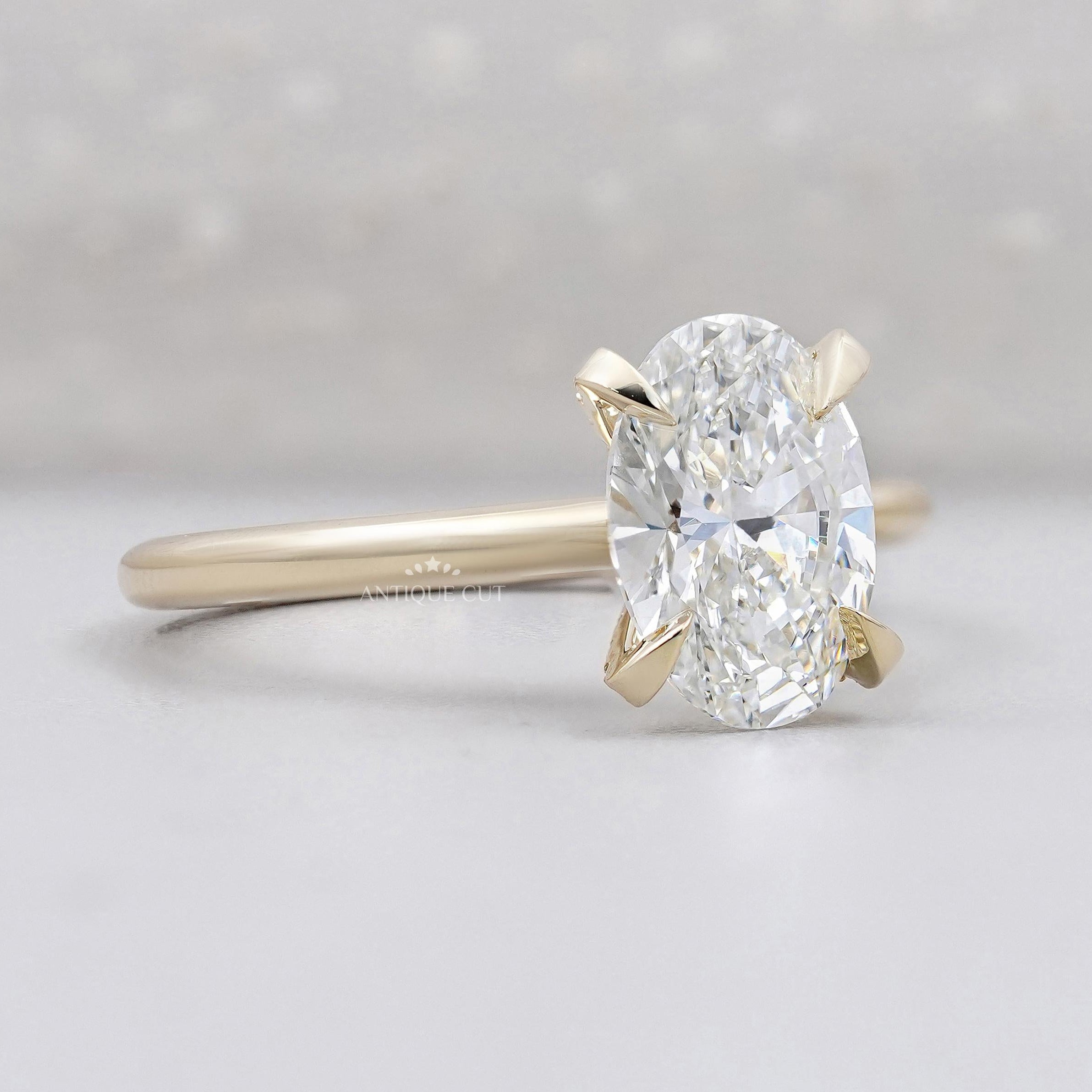 Oval solitaire diamond ring with hidden halo