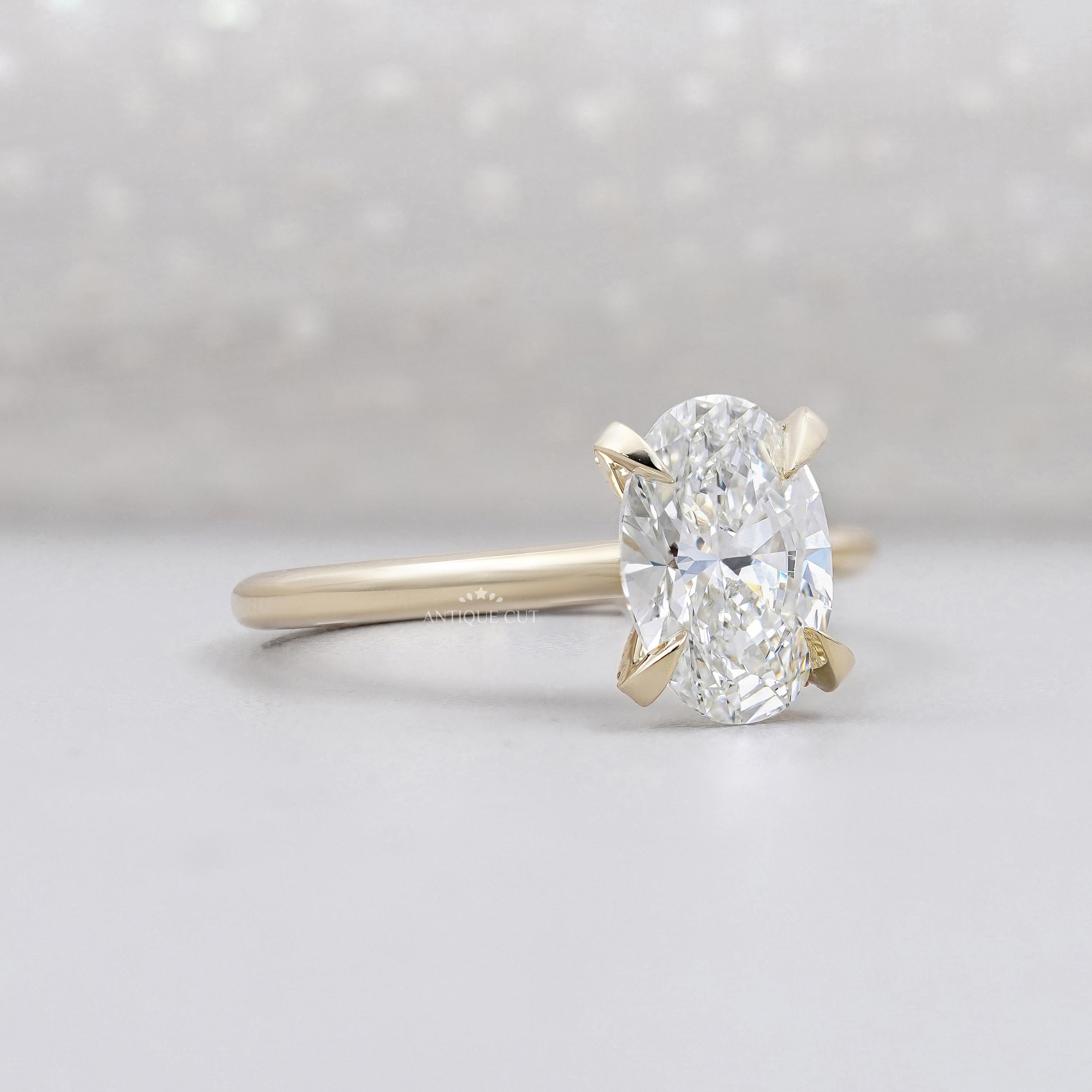 Oval solitaire diamond ring with hidden halo