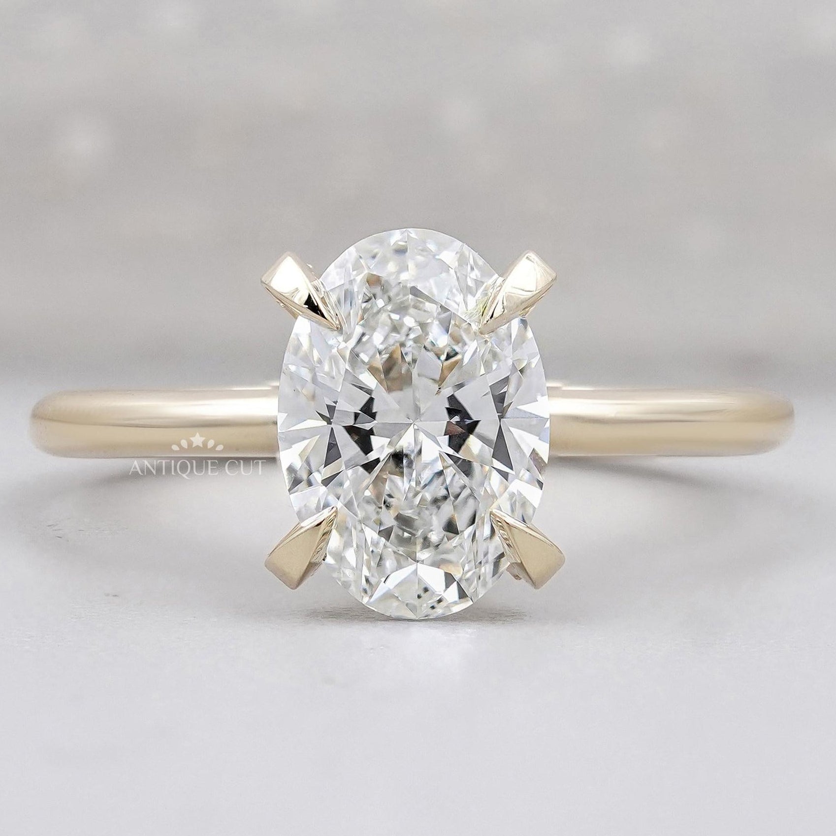 Hidden halo oval engagement ring in yellow gold
