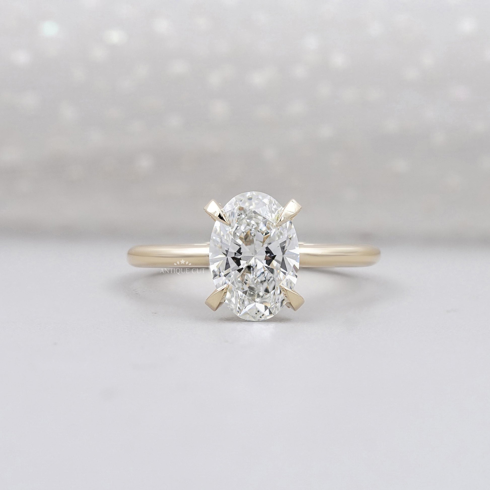 Hidden halo oval engagement ring in yellow gold