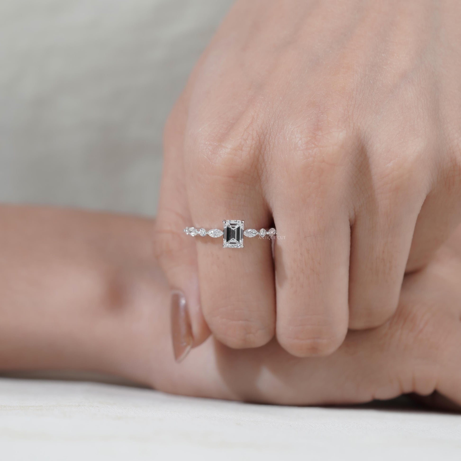 Classic emerald diamond ring with sparkling pave band