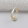 Floral halo diamond ring with twisted white gold band