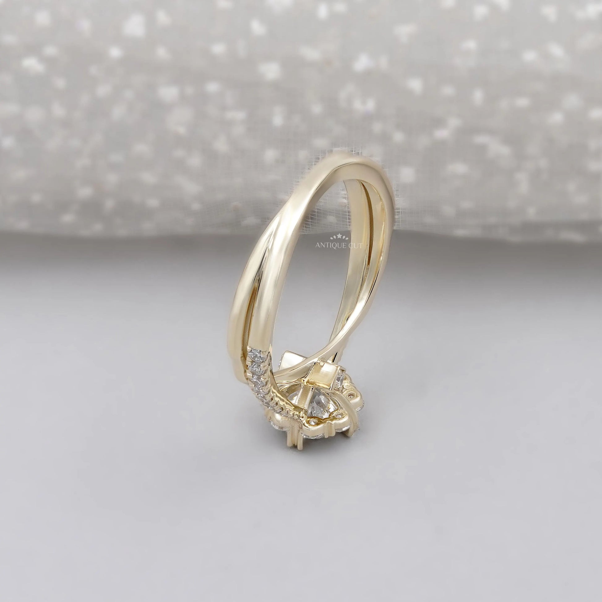 Floral halo diamond ring with twisted white gold band