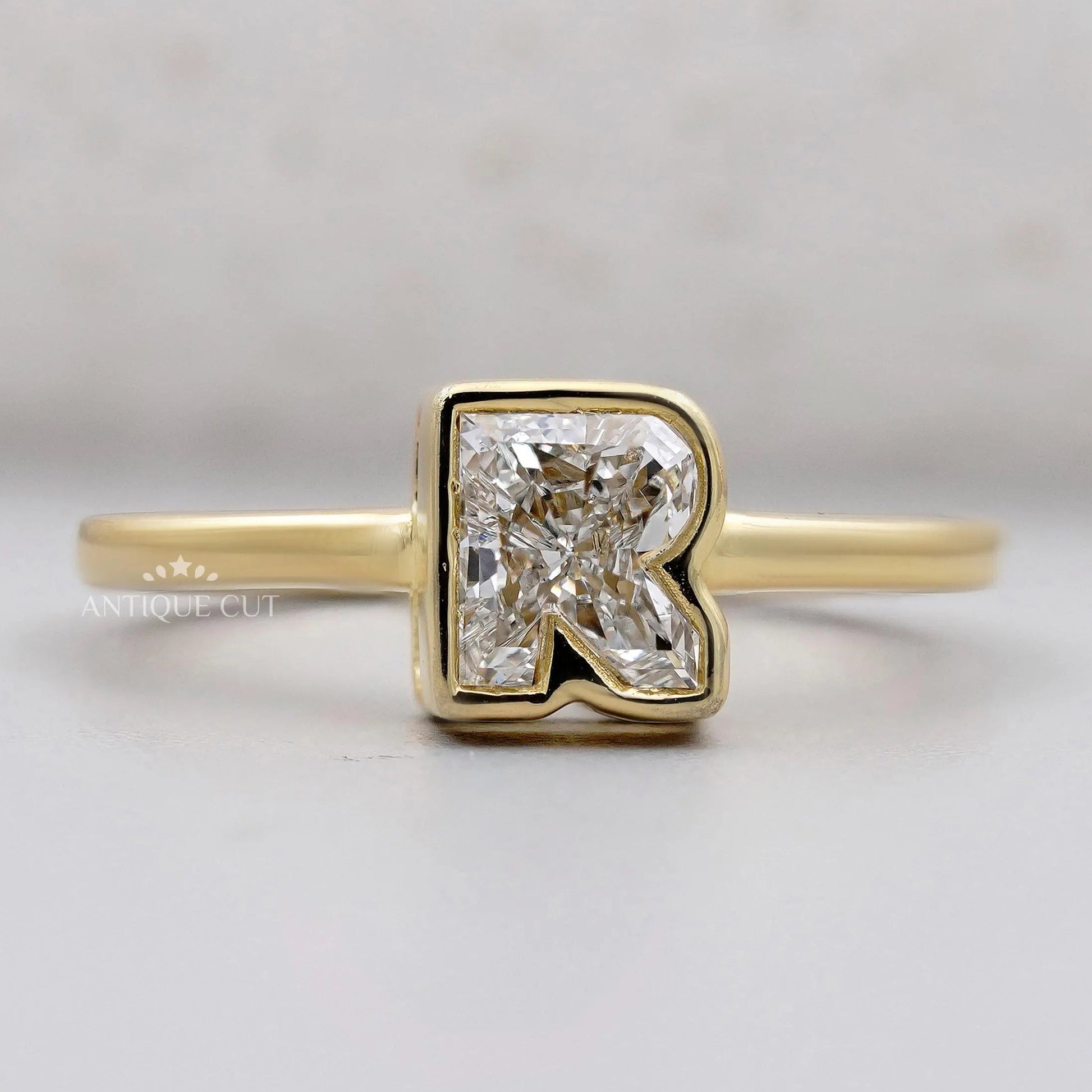R letter ring bezel set diamond yellow gold