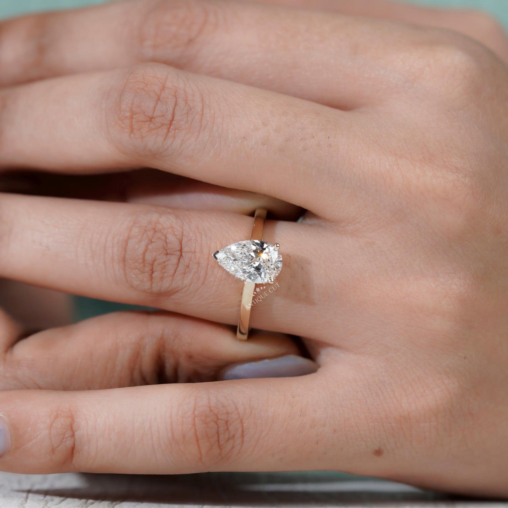 Modern pear shape hidden halo ring