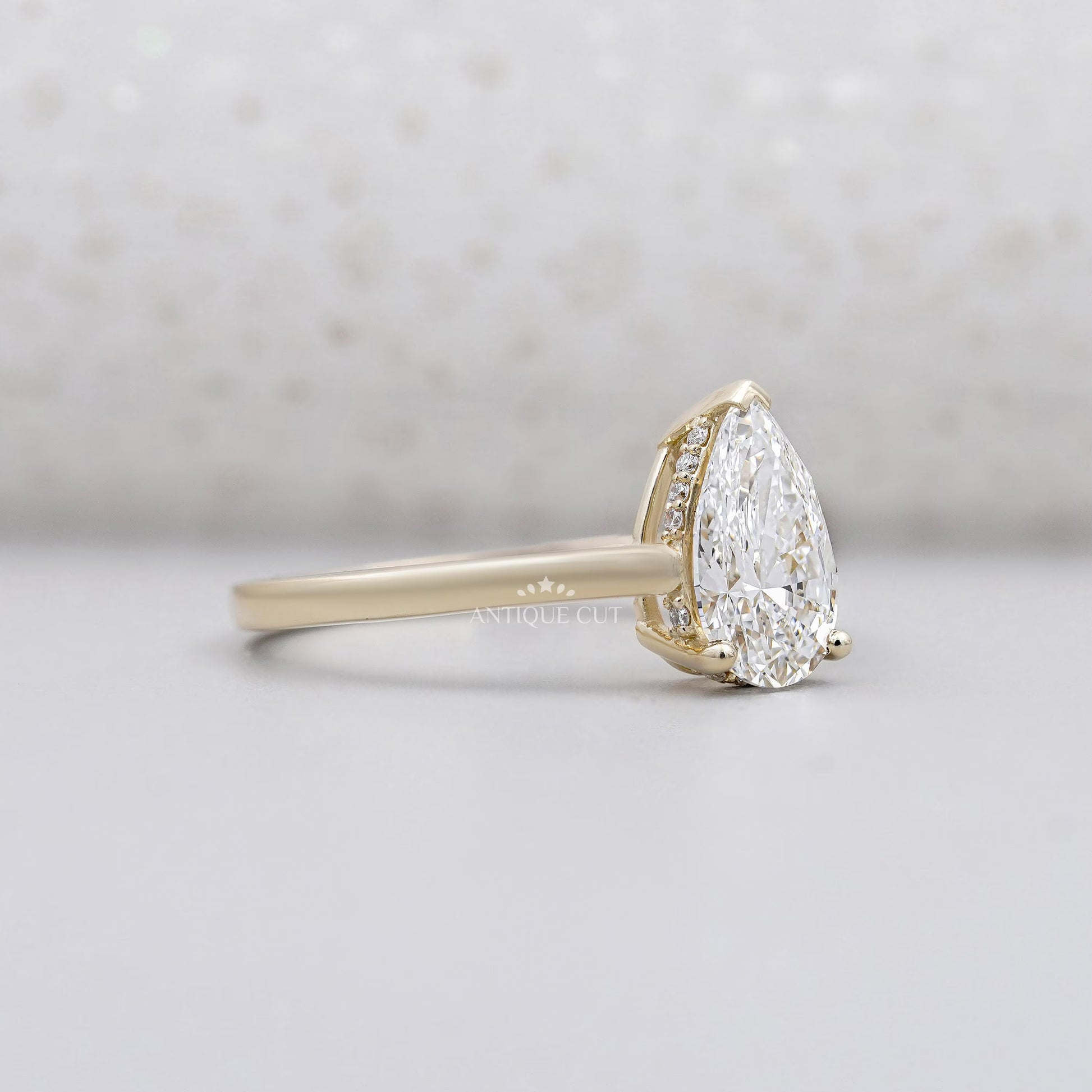 Yellow gold pear engagement ring side view