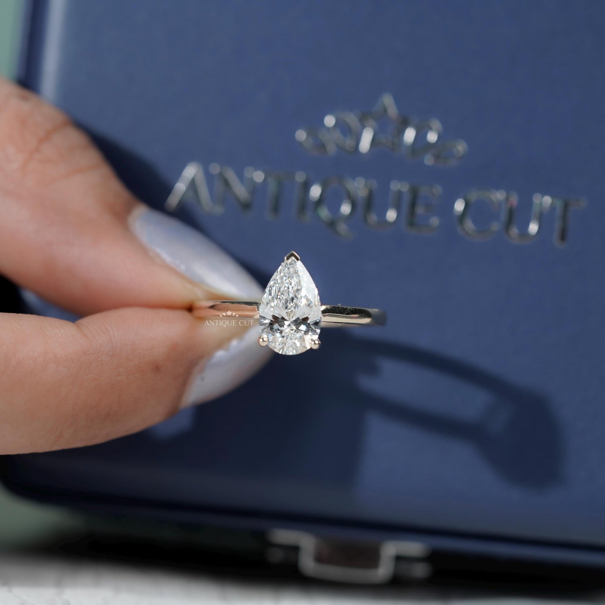 Pear diamond ring with subtle hidden halo