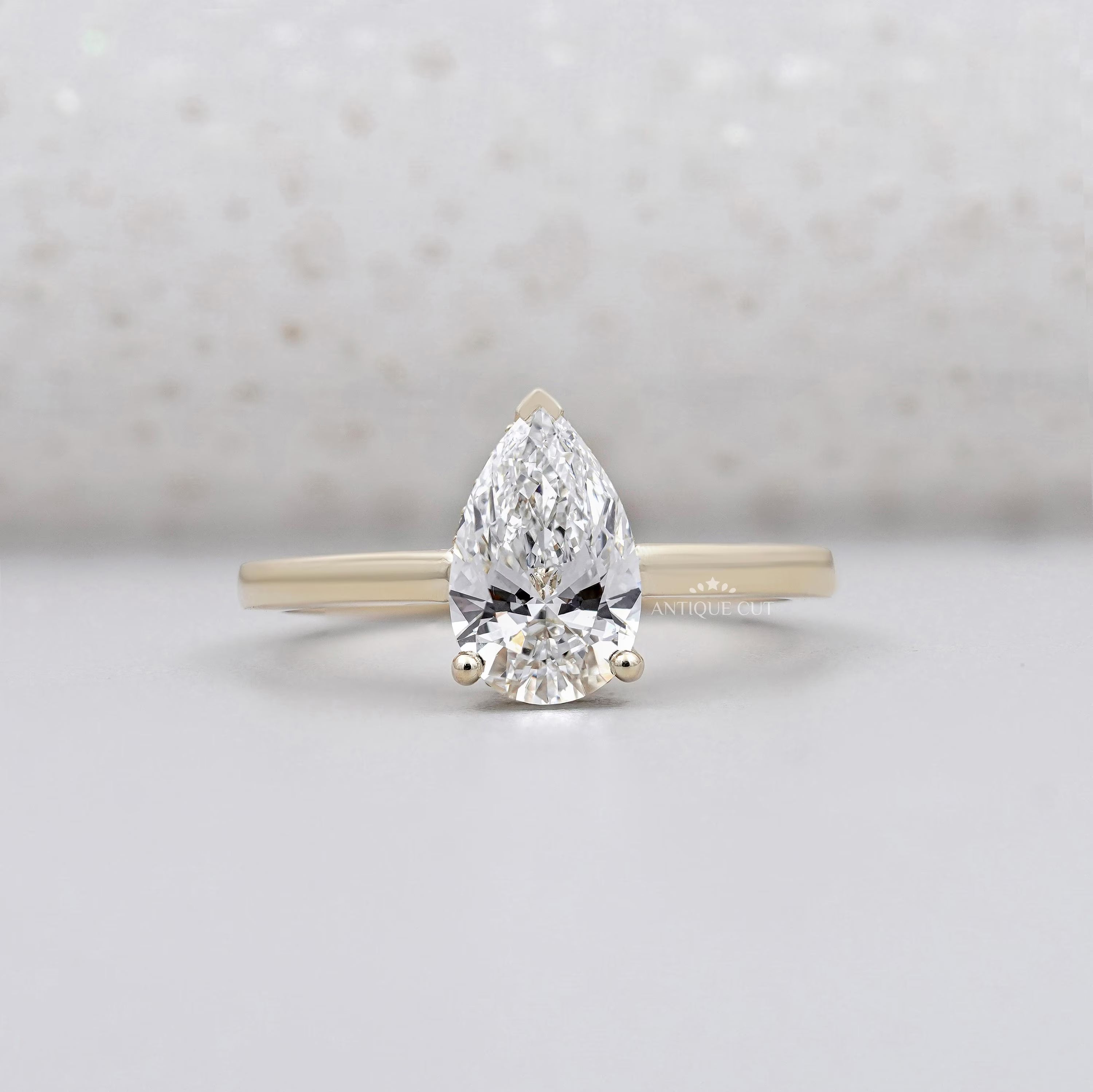 Pear shape engagement ring in yellow gold