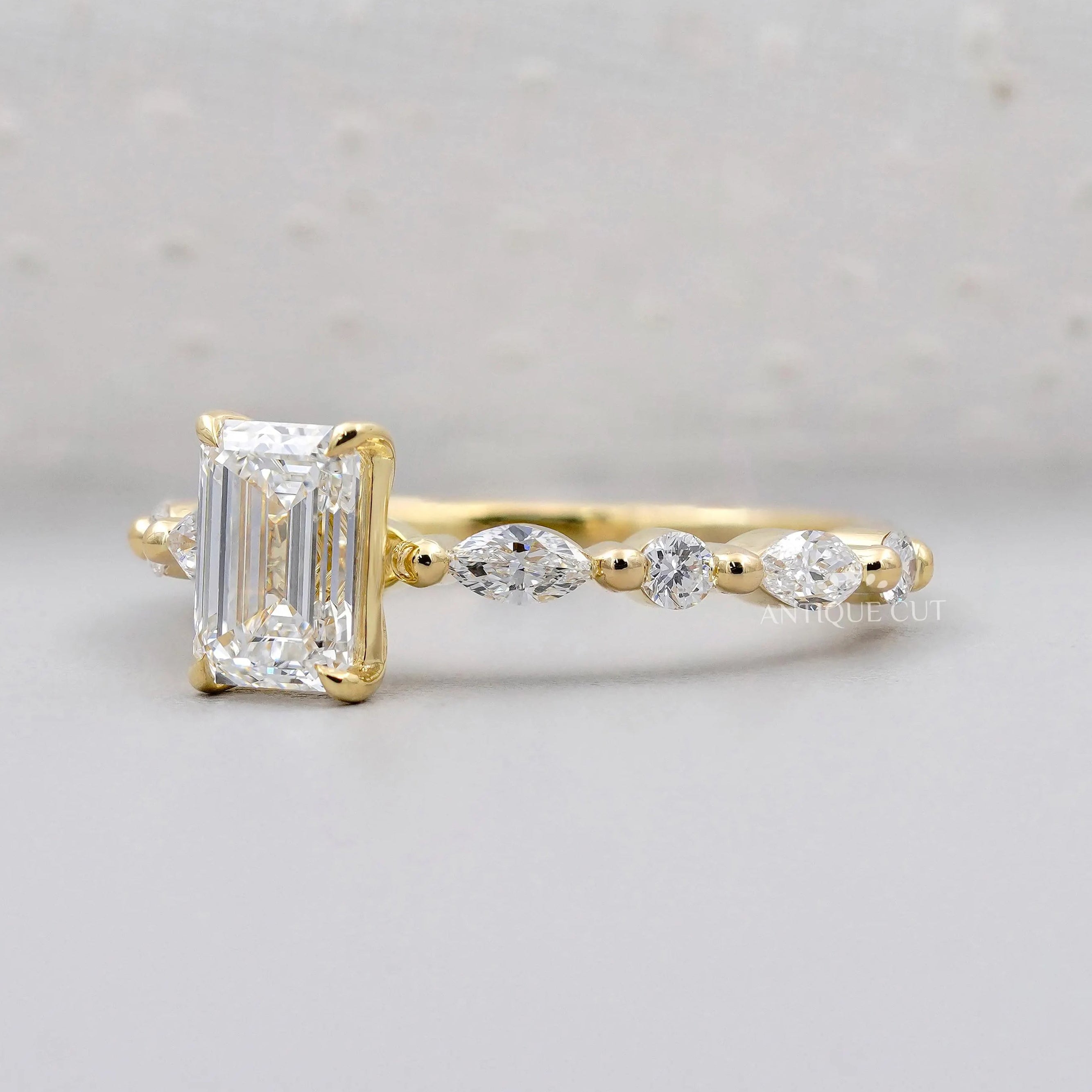 Lab grown emerald cut engagement ring with side diamonds