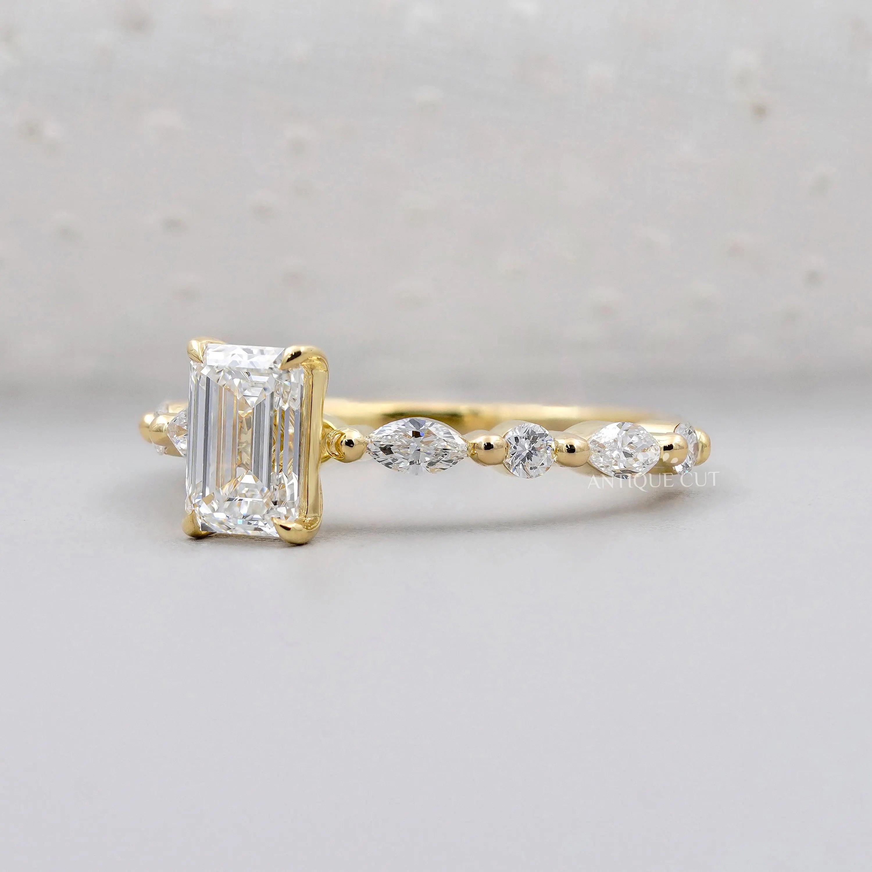 Lab grown emerald cut engagement ring with side diamonds