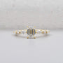 Emerald cut engagement ring in yellow gold with side stones