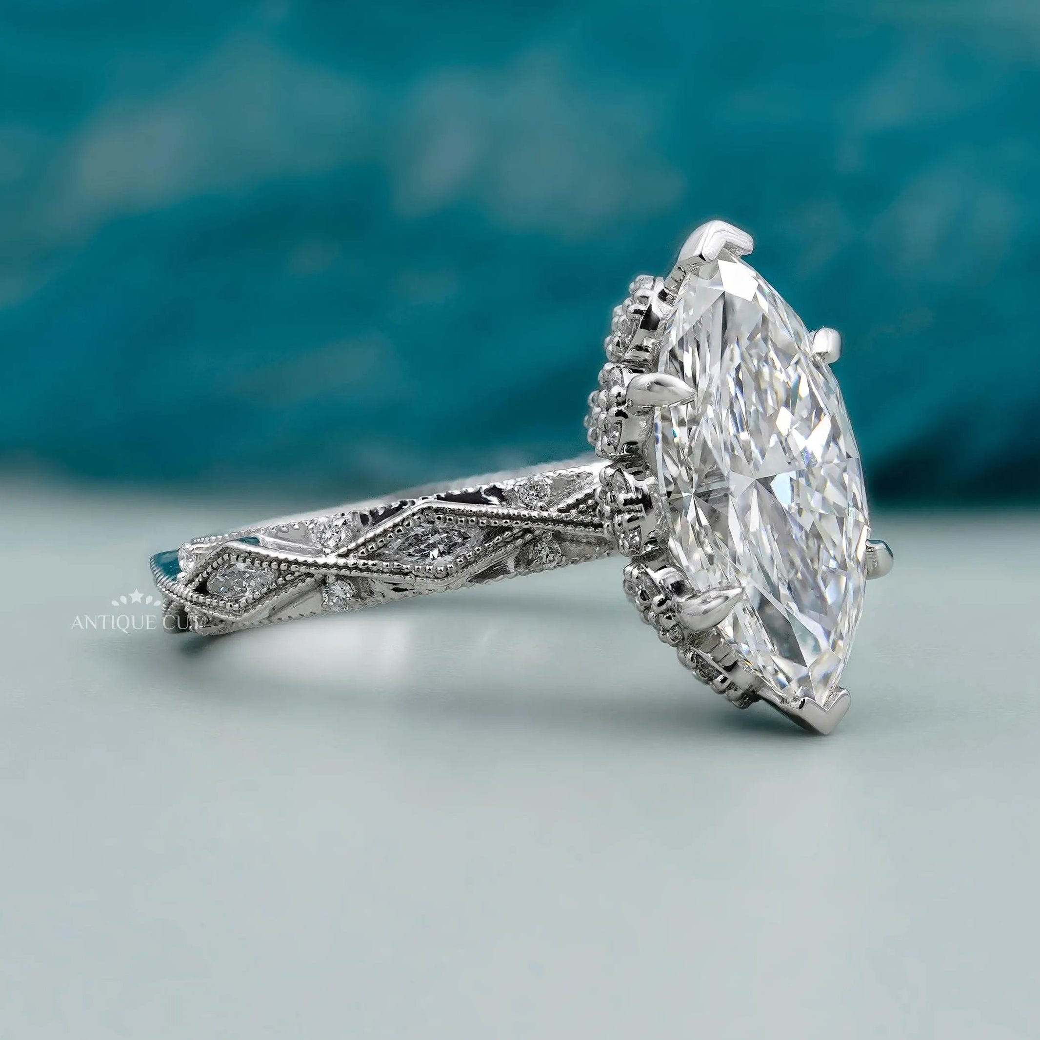Marquise diamond ring with hidden halo round diamonds