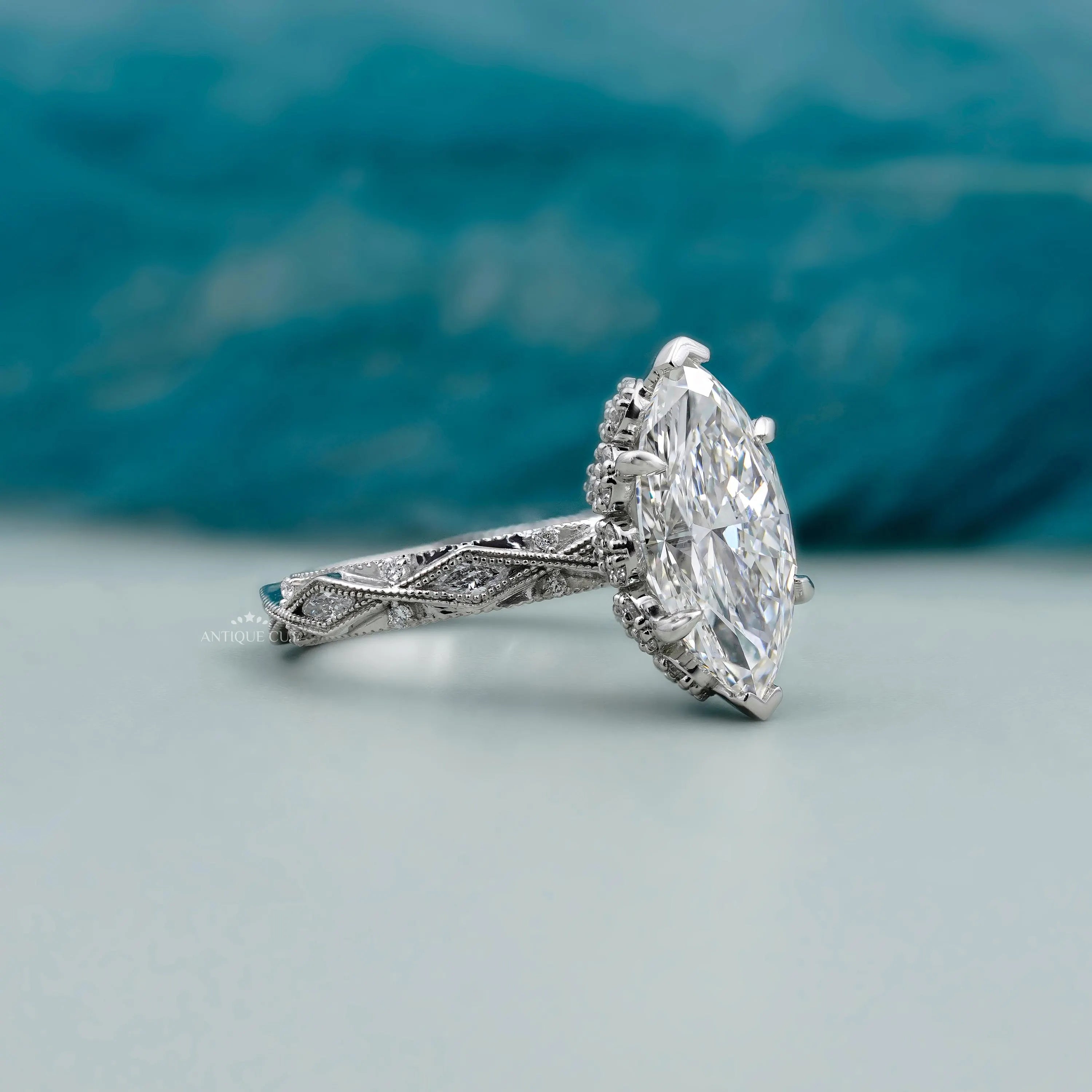 Marquise diamond ring with hidden halo round diamonds