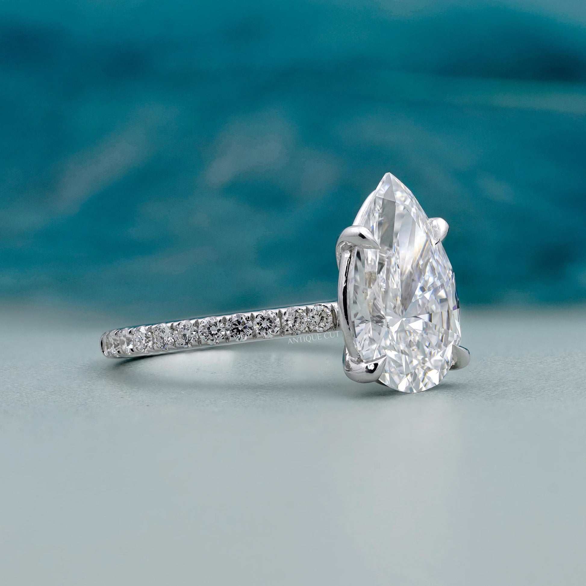 Lab grown pear shaped engagement ring with side stones